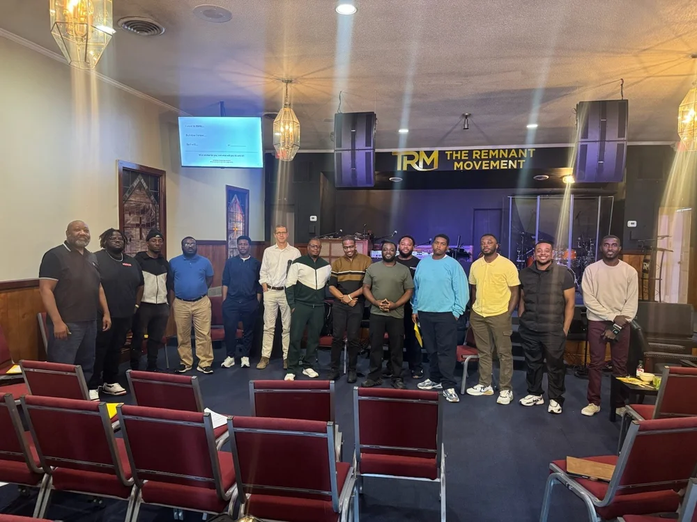 Men's fellowship group photo in the sanctuary at The Remnant Movement