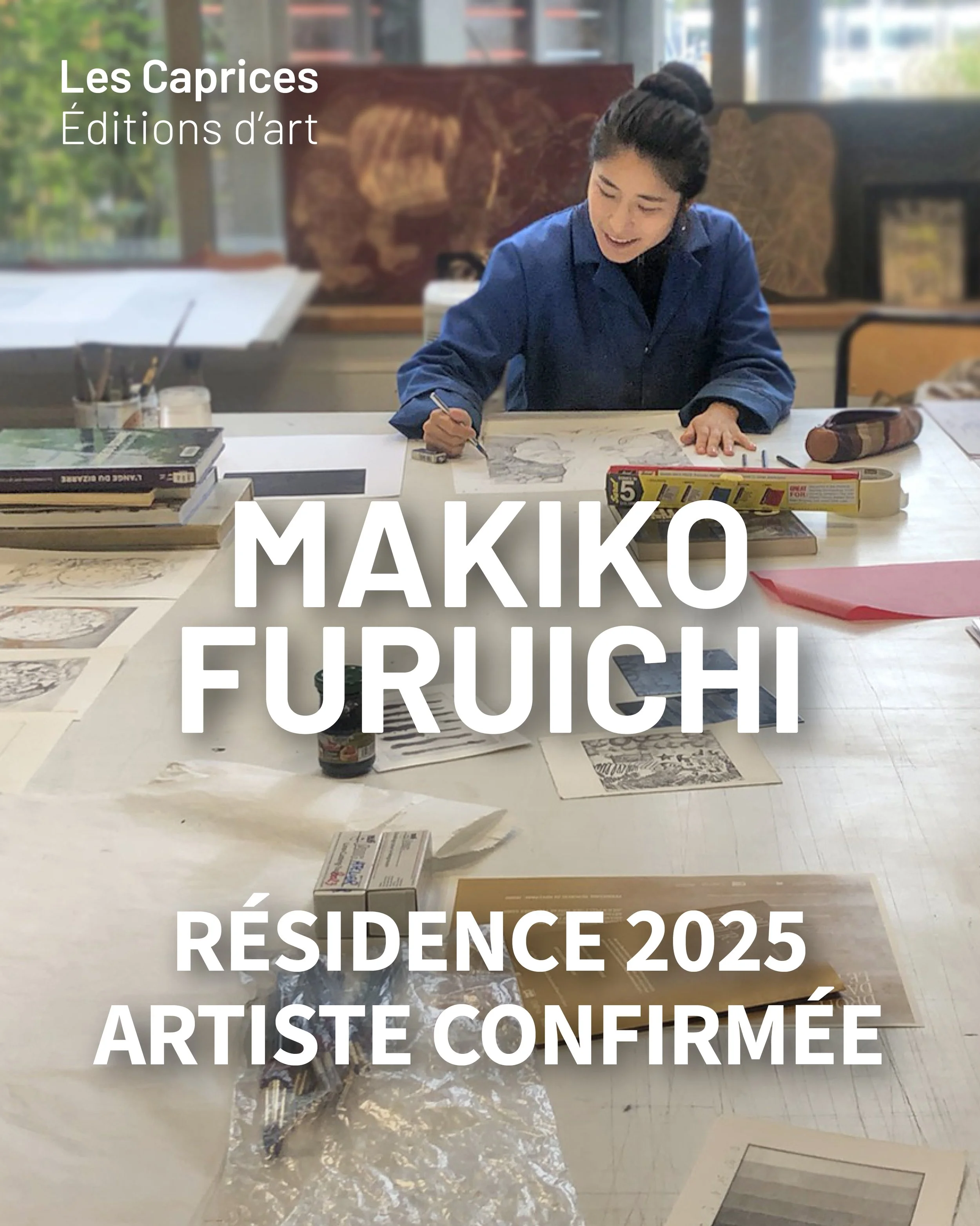 Une femme assise à une table, s'apprêtant à dessiner ou à peindre, avec des livres, des pinceaux, et d'autres outils artistiques devant elle. La pièce semble être un atelier ou une espace créatif.
