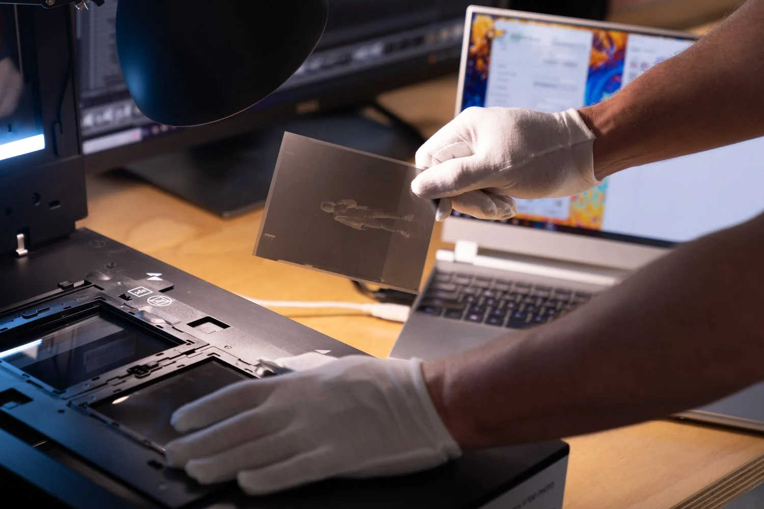 Member scanning photographic film using the Epson V700 flatbed scanner in the Great Space members workspace.