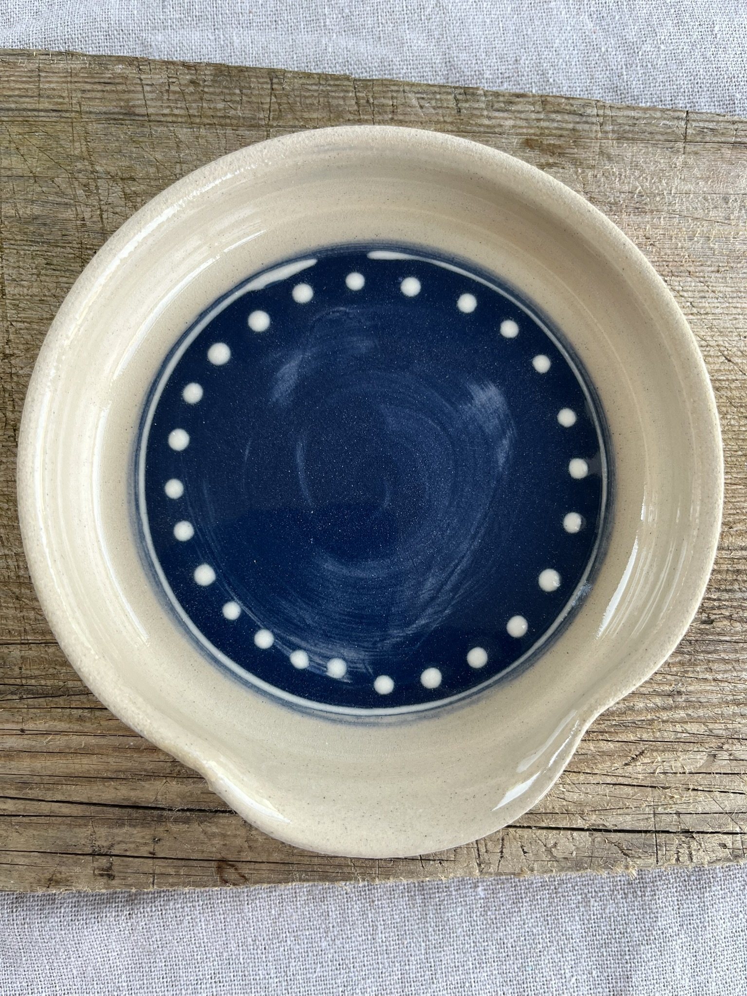 Blue, stoneware spoon rest with white slip trailing