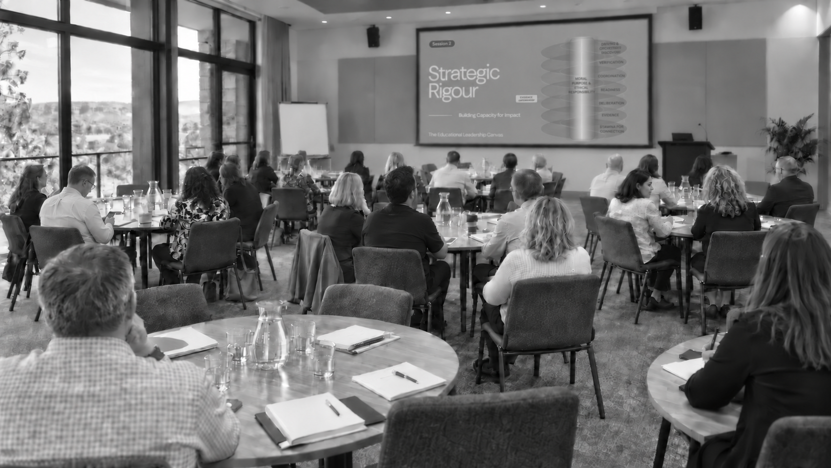 Leaders in a room looking towards whiteboard
