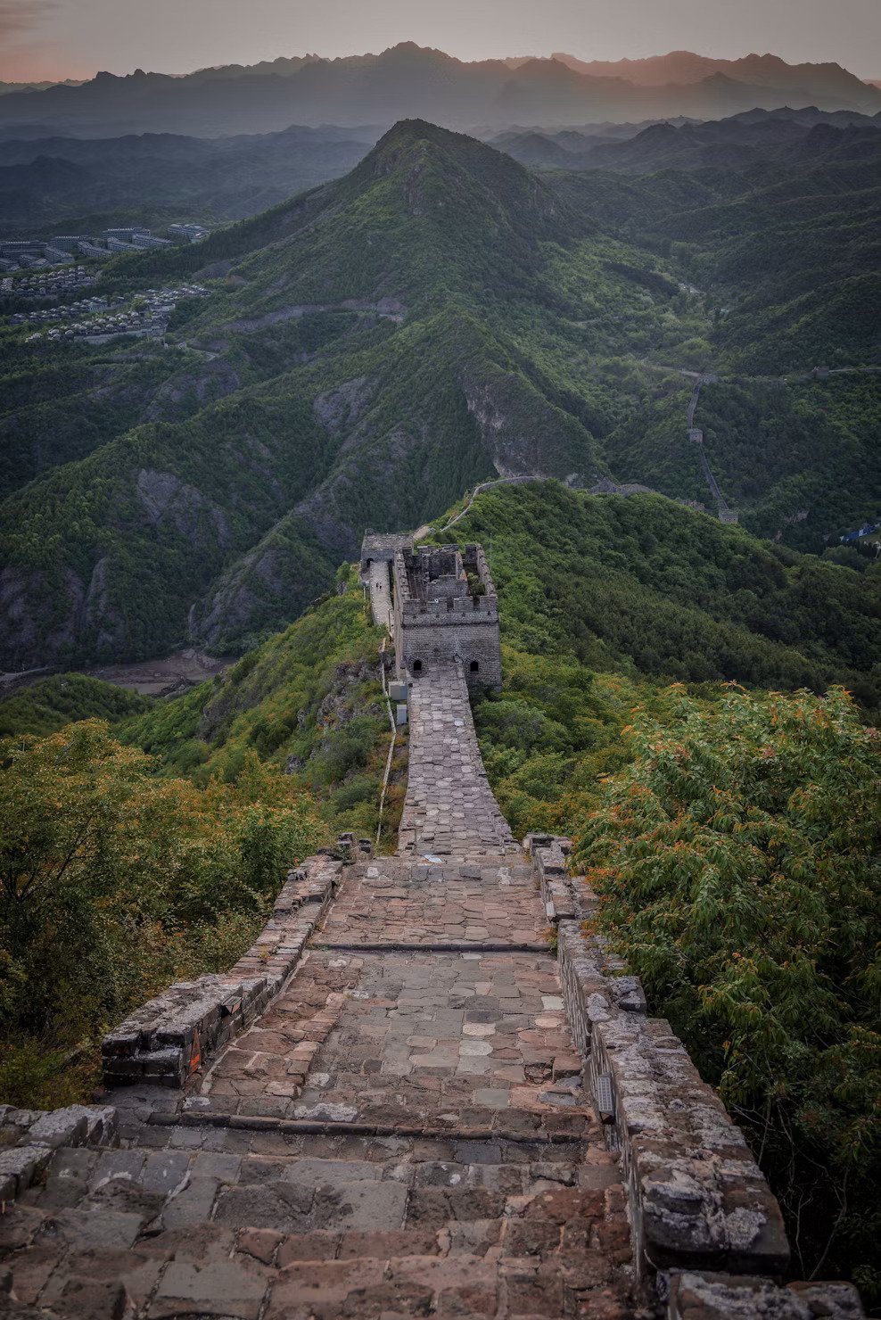 Great Wall winding through lush green mountains