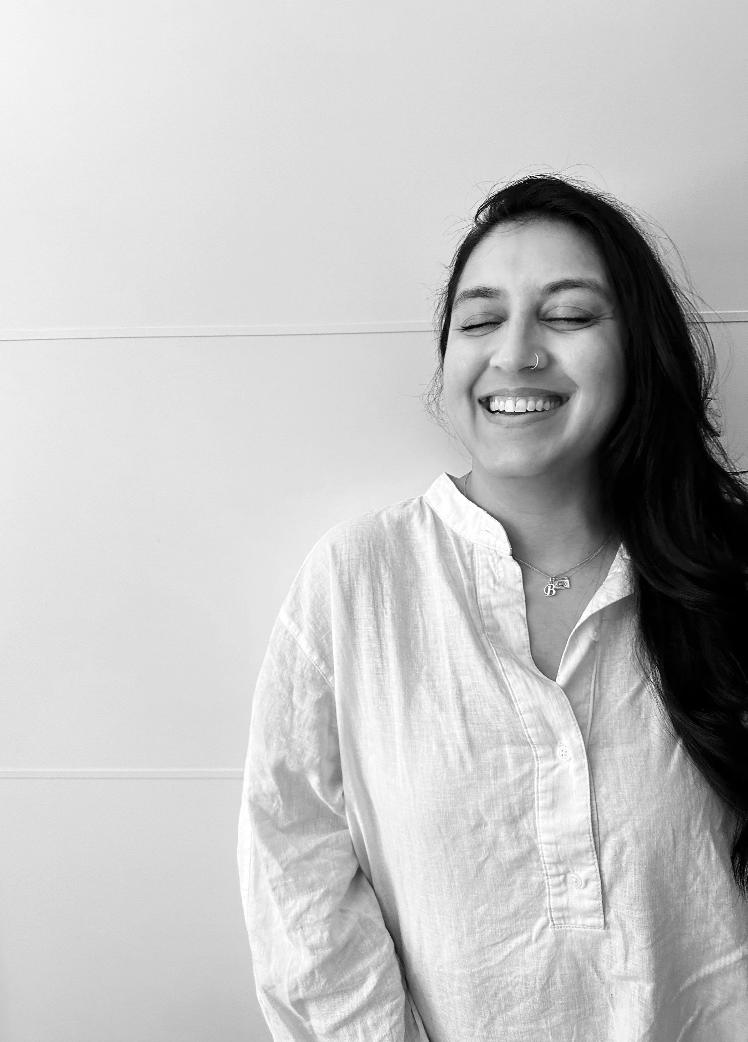 Bhav laughing, person-centred hypnotherapist at The Līlā Room in Surrey