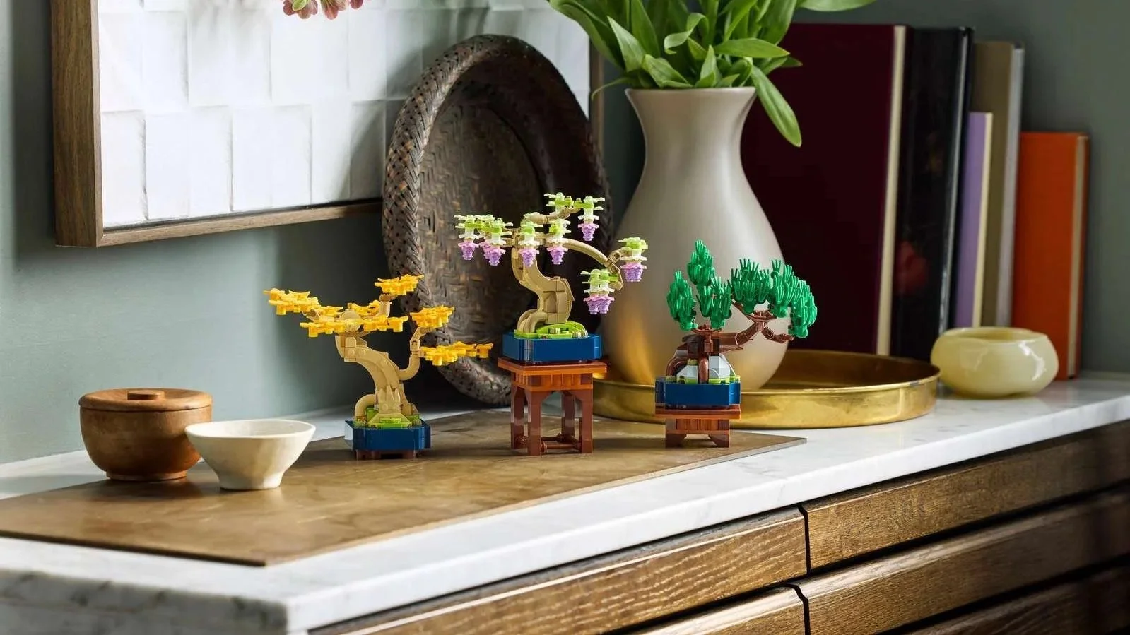 Mini_Bonsai_Trees_on_the_drawer.jpg LEGO Mini Bonsai Trees in yellow, purple, and green displayed on a marble sideboard with books and a tall vase