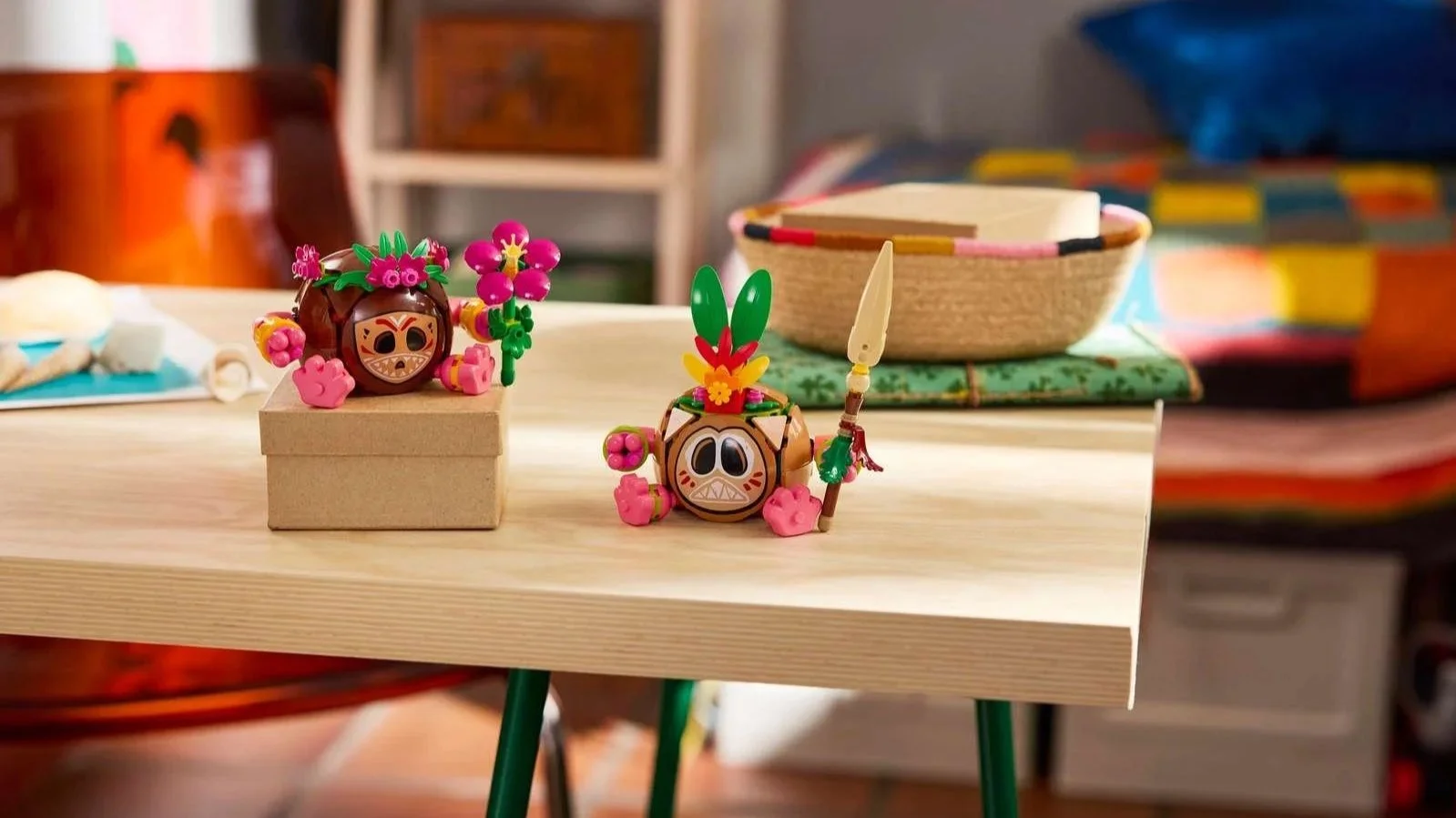 LEGO Disney Moana Kakamora set with two small coconut warriors on a table, one with a flower crown and pink flower, the other with a feather headdress and spear