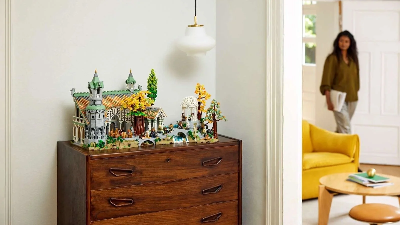 LEGO Rivendell set from The Lord of the Rings with autumn trees displayed on a wooden dresser