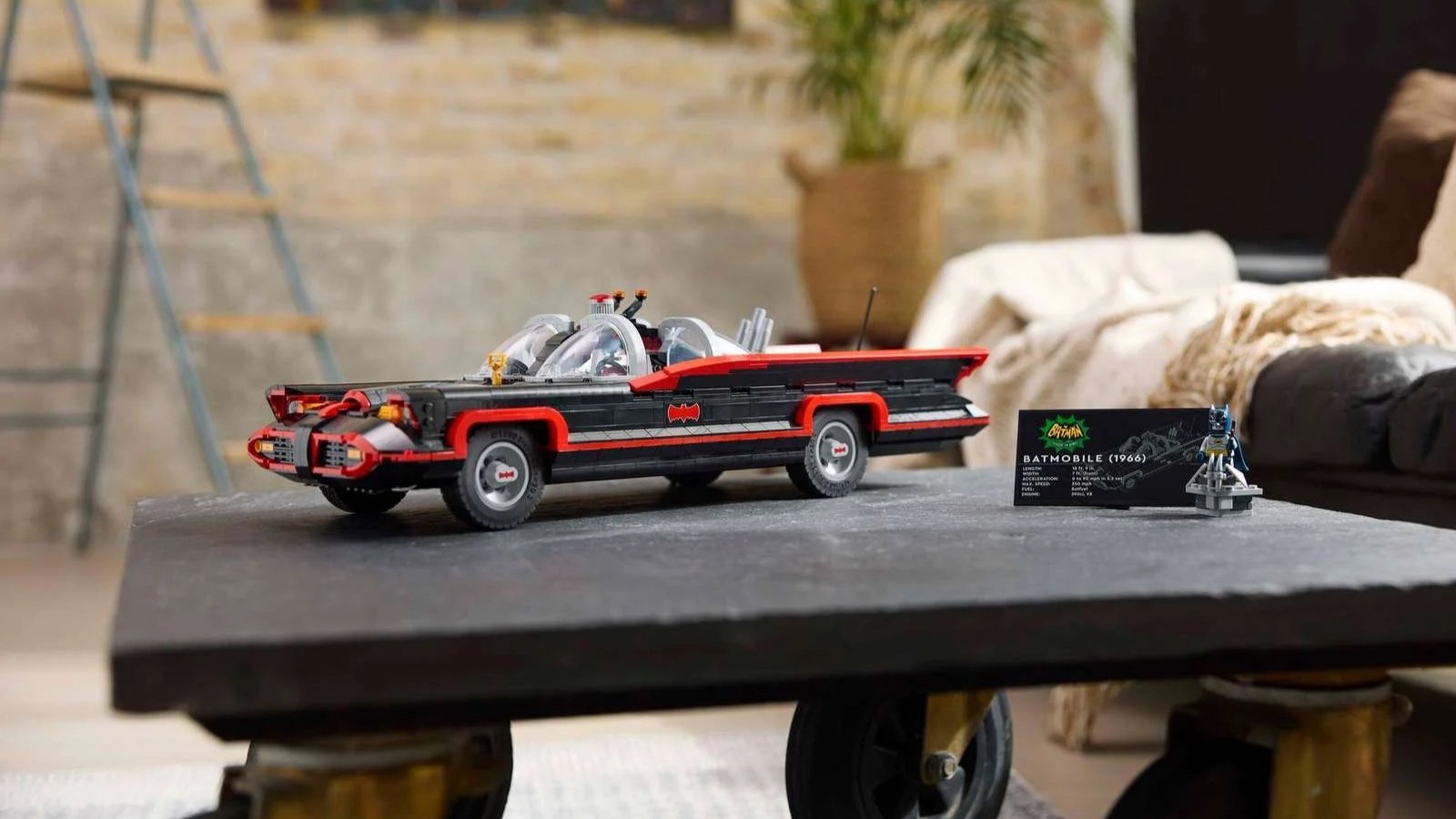 LEGO Batman Classic TV Series Batmobile set with a Batman figure on a slate coffee table