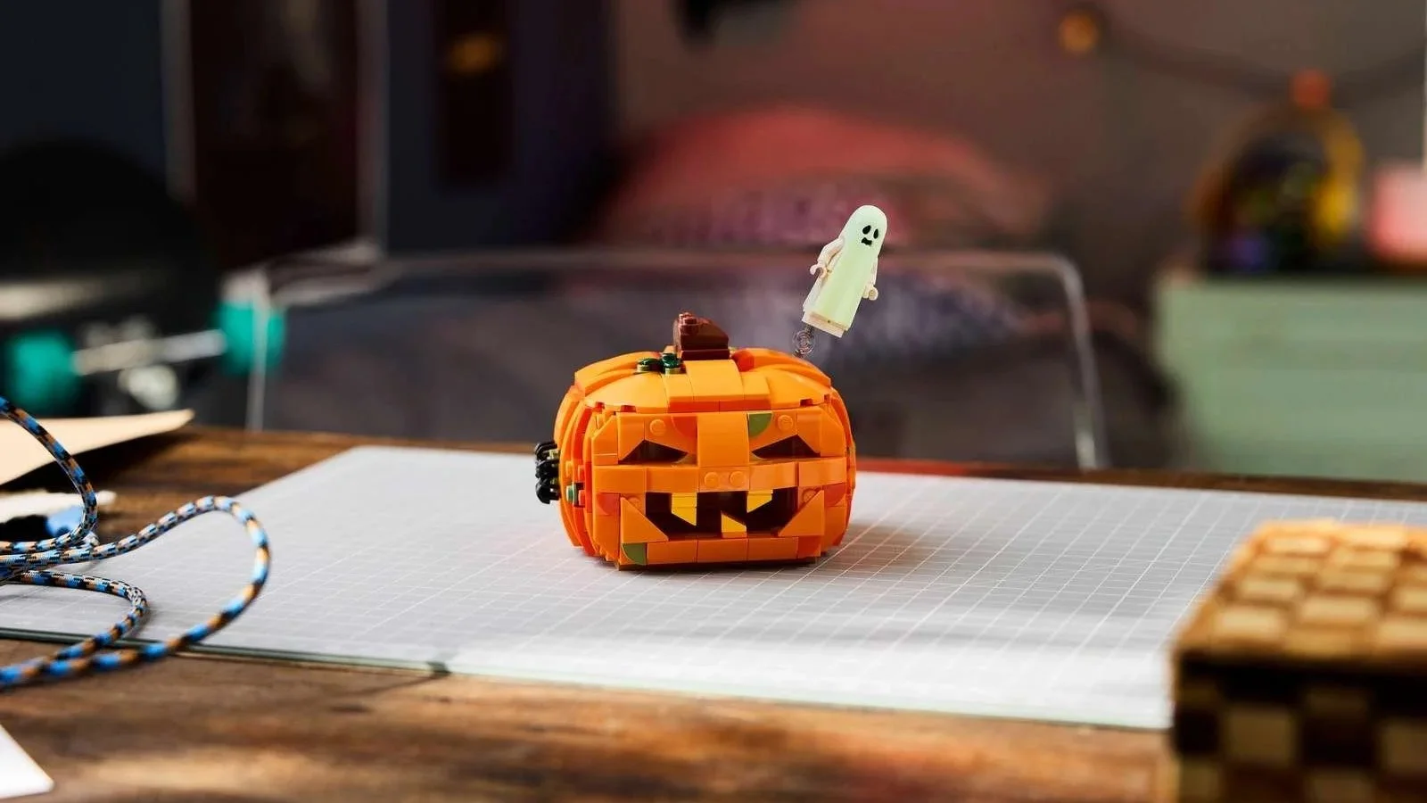 LEGO Halloween Pumpkin Lantern set with a carved grin and a small pale green ghost floating beside it