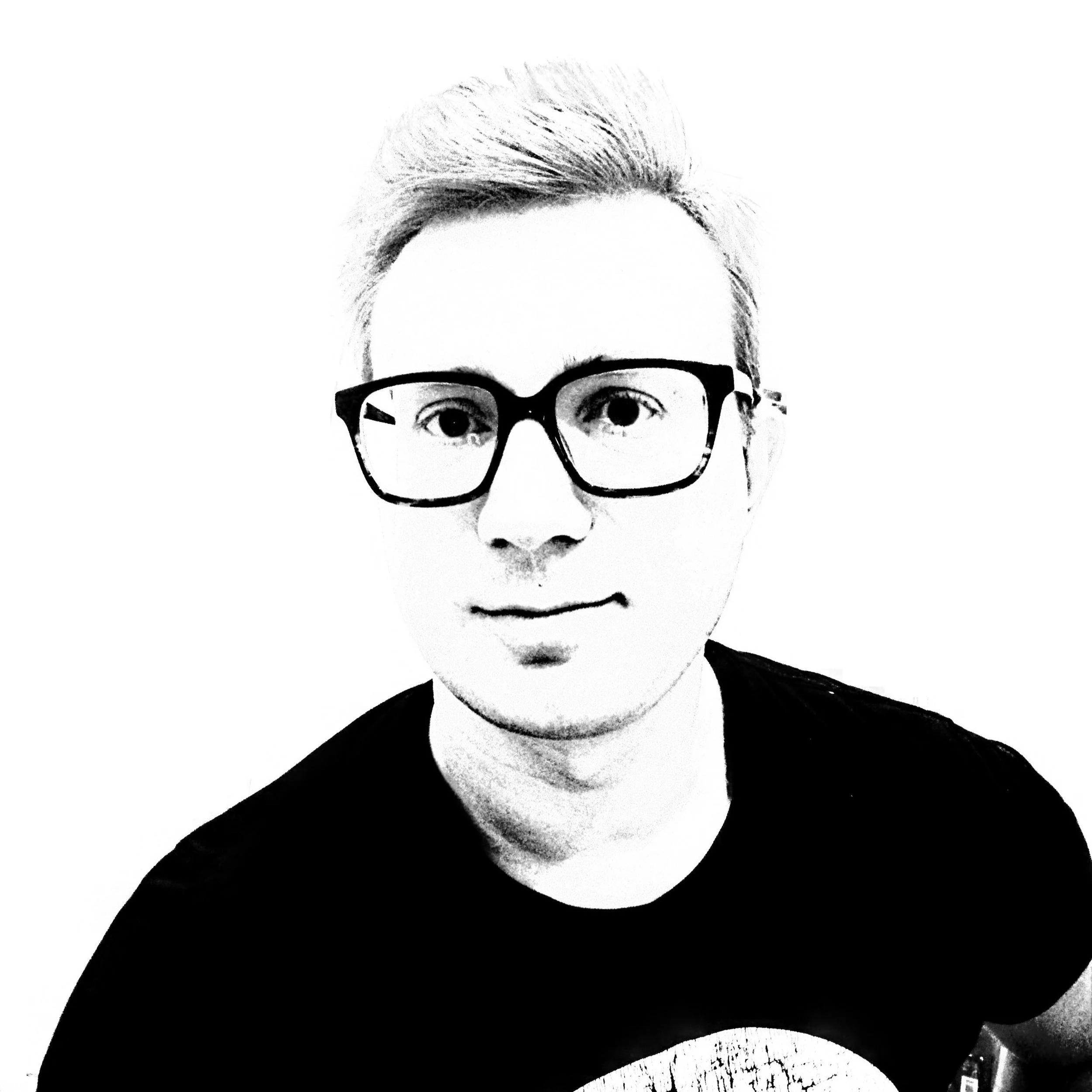 Black and white picture of Paweł Uciekałek wearing glasses.