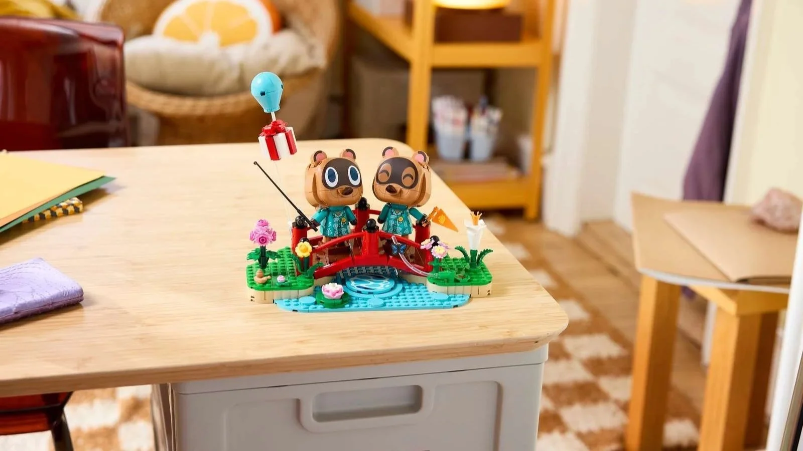 LEGO Animal Crossing Timmy & Tommy's Fun Day Out set with a red bridge and lily pond, sitting on a wooden table
