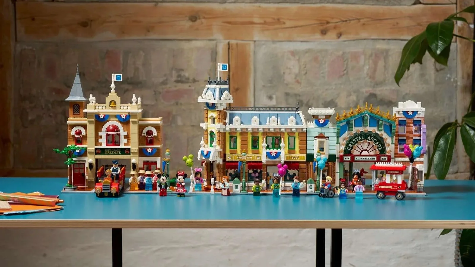 LEGO Disney Main Street, U.S.A. set with Mickey and Minnie minifigures displayed on a blue table
