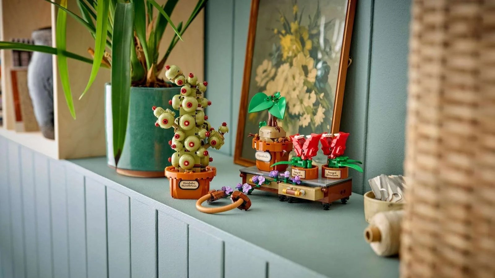 LEGO Hogwarts Herbology Plants set with potted Mandrake and Fanged Geranium builds on a sage green counter
