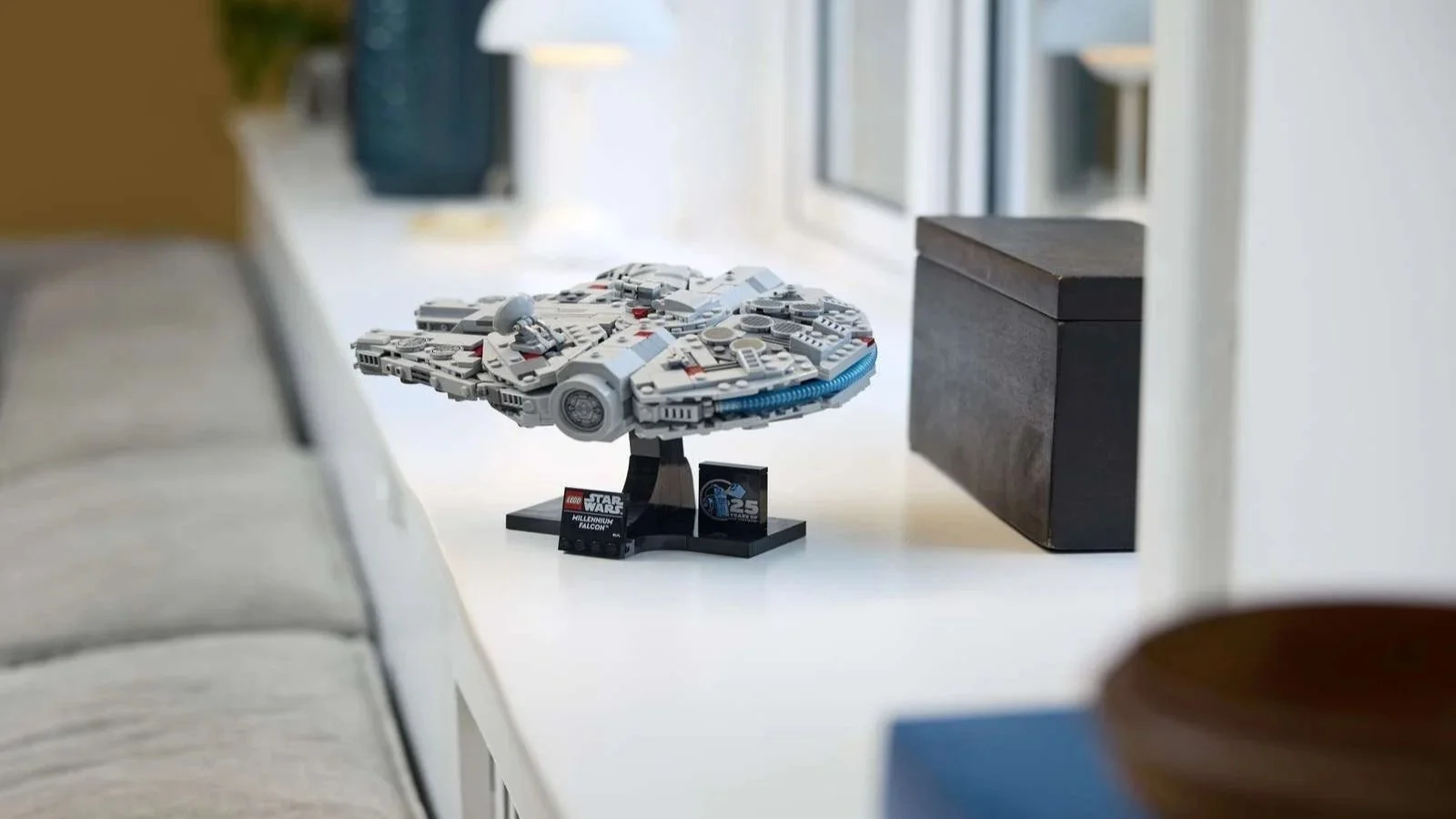LEGO Star Wars Millennium Falcon set on its display stand along a white counter by a sunny window