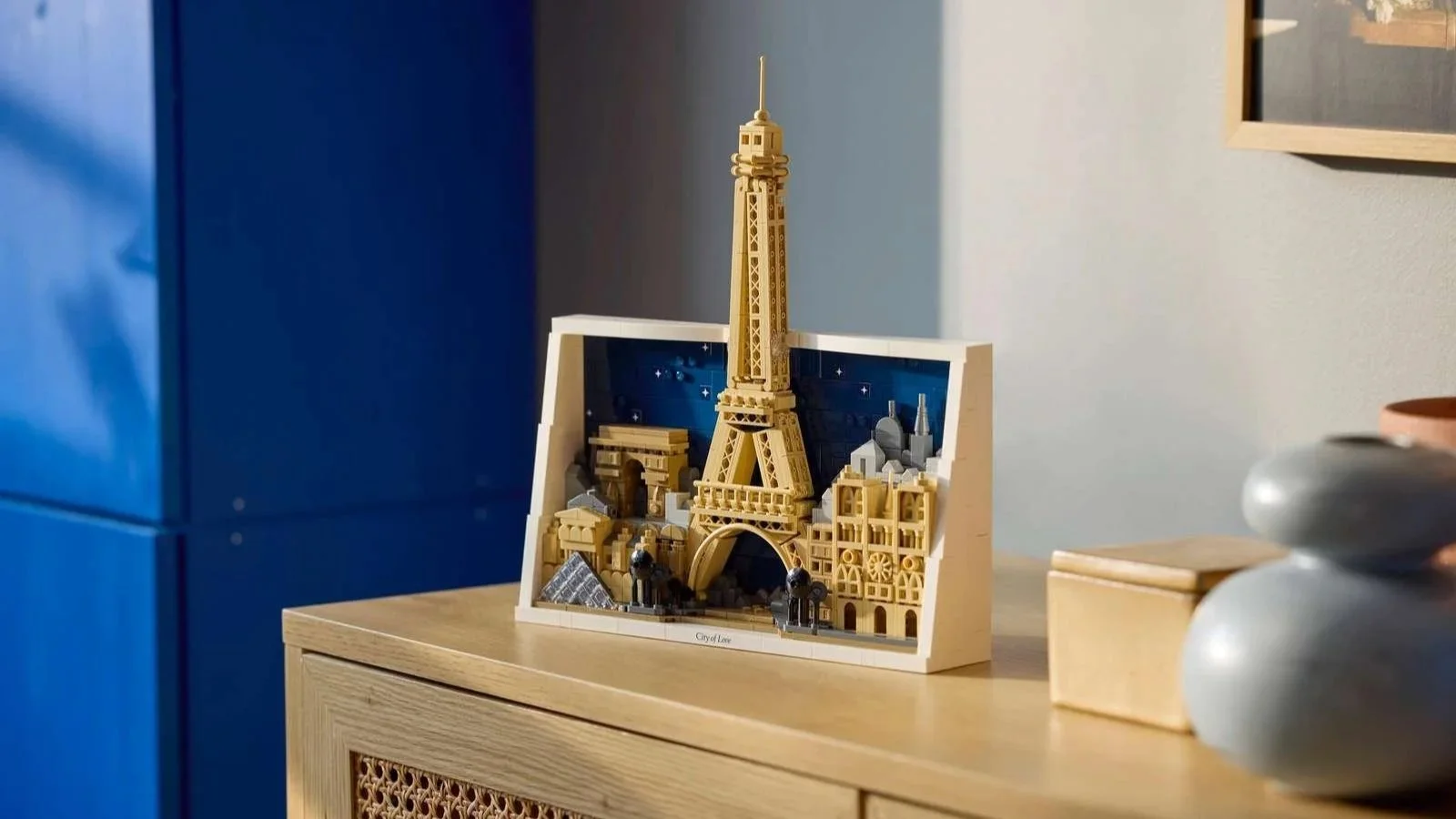 LEGO Architecture Paris City of Love set with the Eiffel Tower against a starry backdrop on a sunlit wooden sideboard