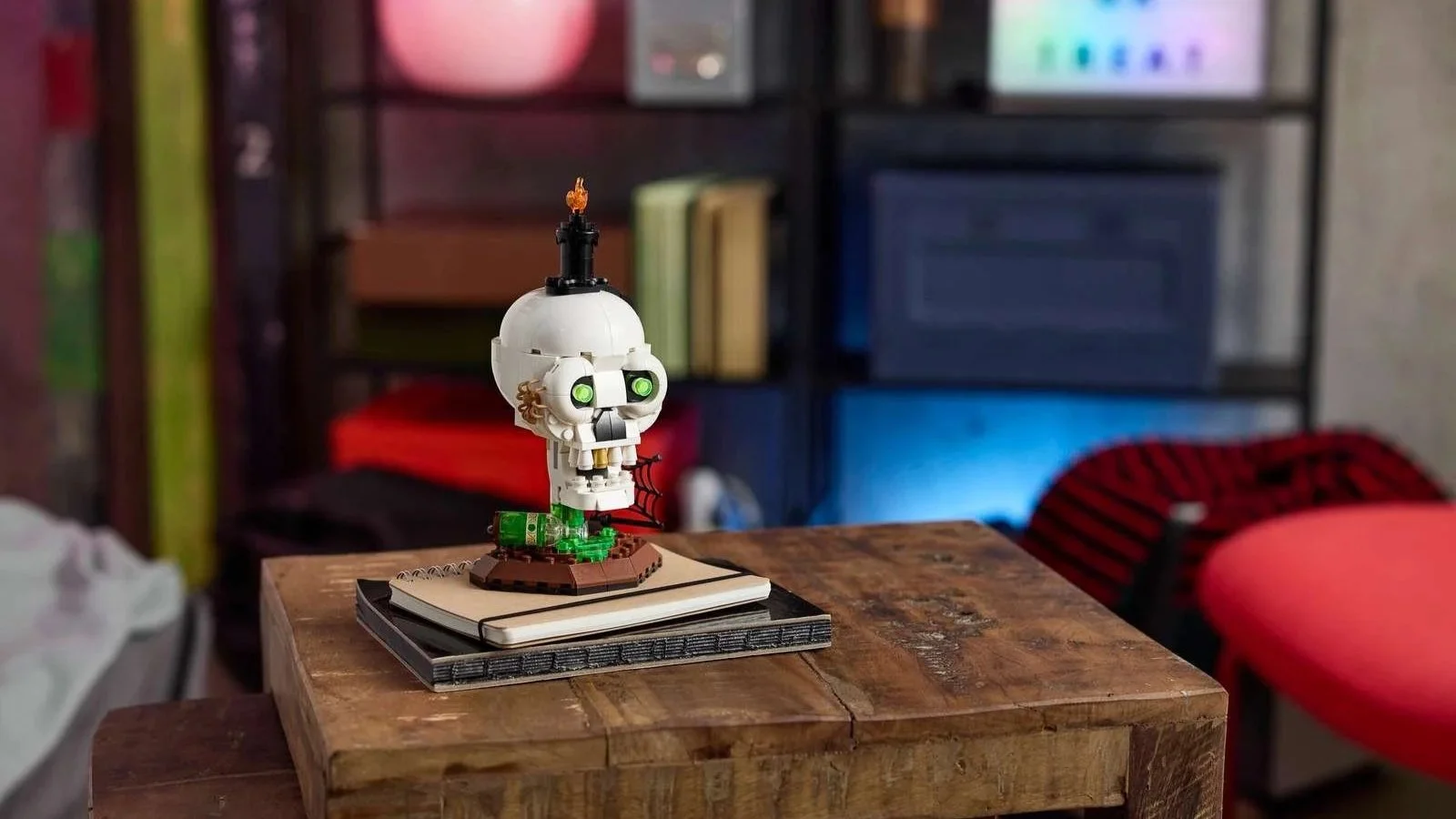 LEGO Halloween Skull Candle set with glowing green eyes and a flame on top, displayed on a rustic wooden side table