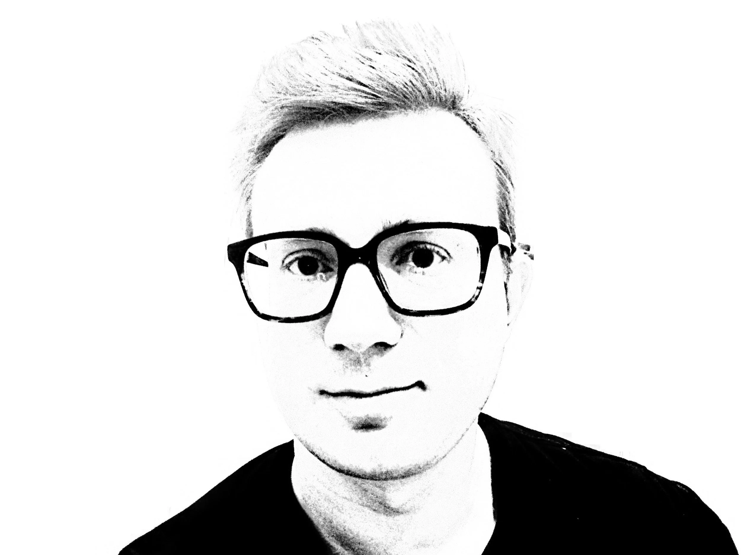 Black and white picture of Paweł Uciekałek wearing glasses.