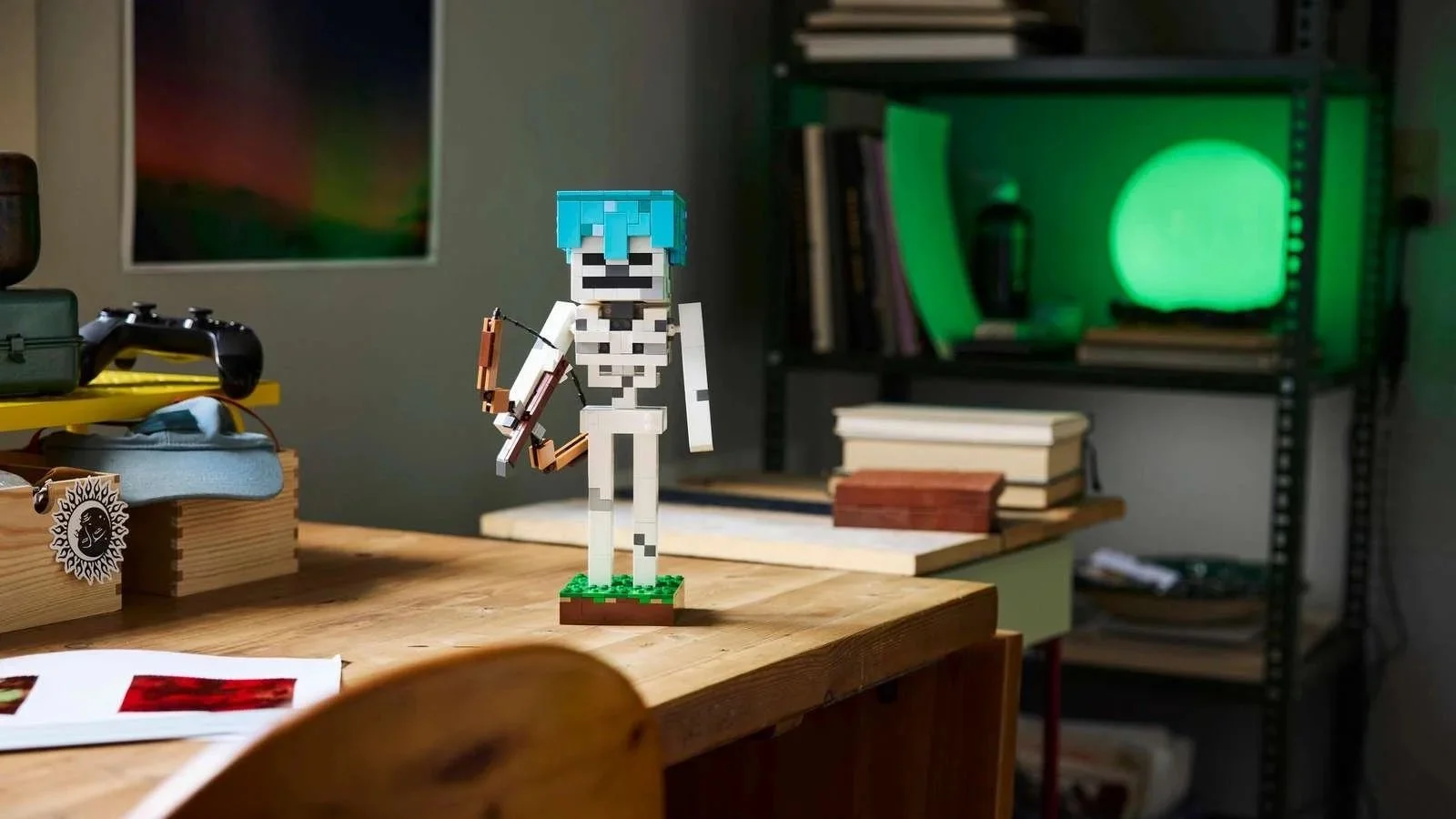 LEGO Minecraft Skeleton figure holding a bow on a wood desk, with books and a game controller nearby