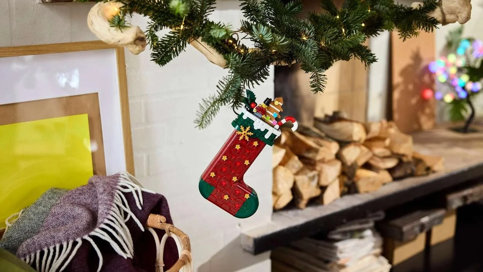 LEGO Christmas stocking with gold stars hanging from a pine branch, filled with a candy cane, gingerbread tree and toy soldier
