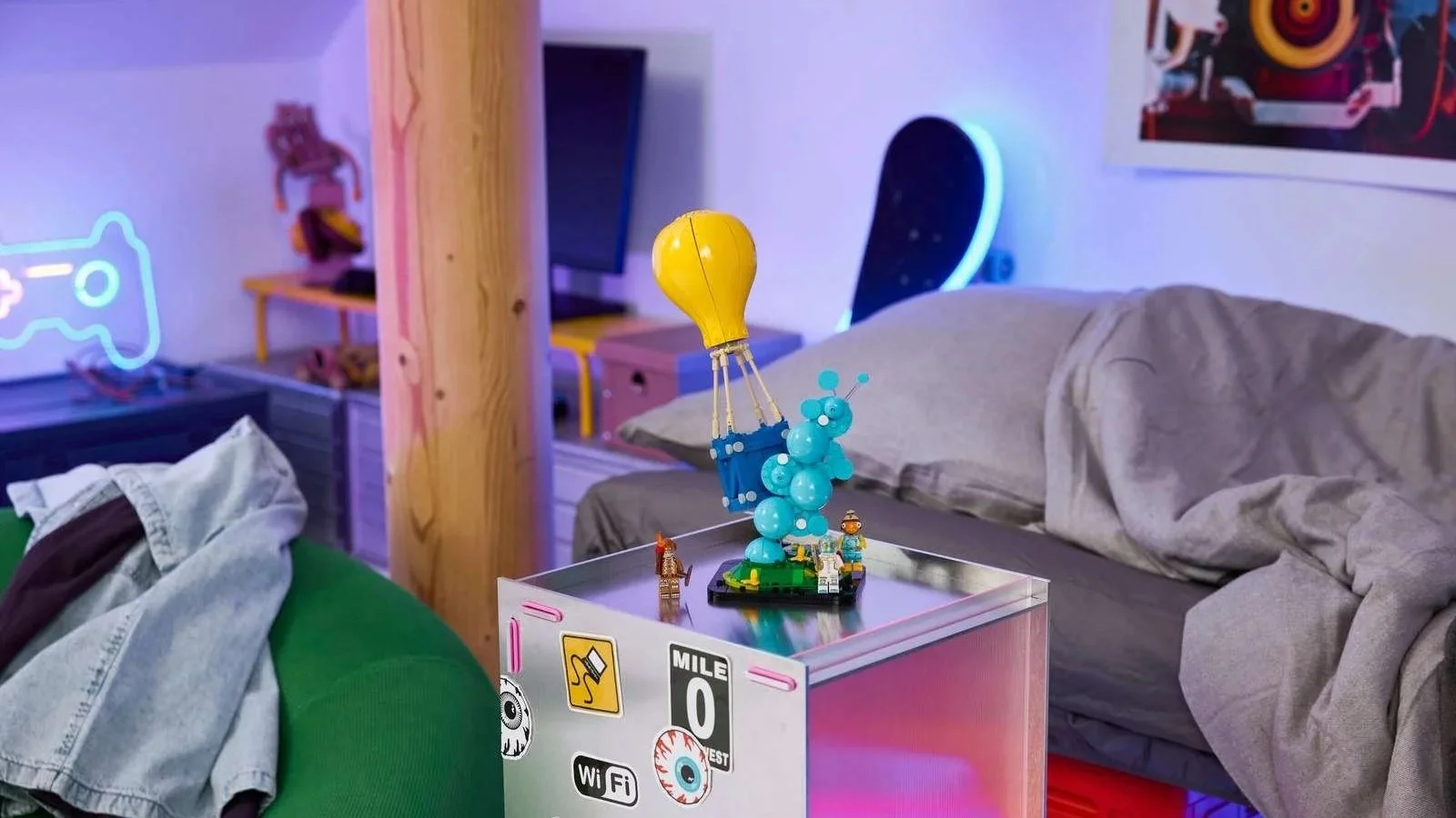 LEGO Fortnite Supply Drop set with its yellow balloon and two minifigures on a sticker covered drawer in a neon lit bedroom