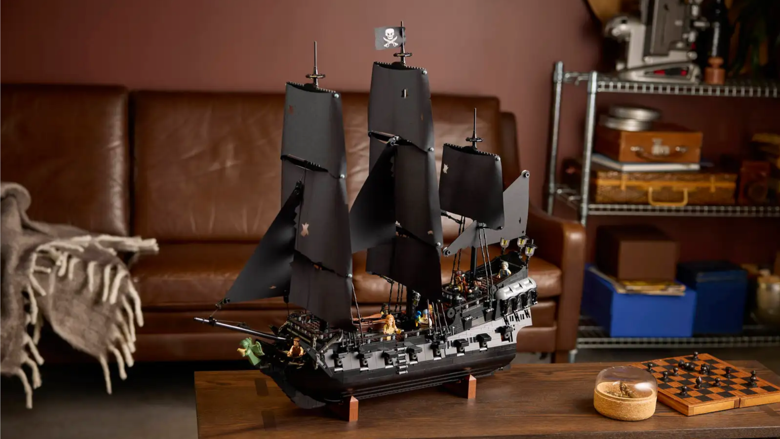 LEGO Captain Jack Sparrow's Pirate Ship set with black sails displayed on a living room coffee table