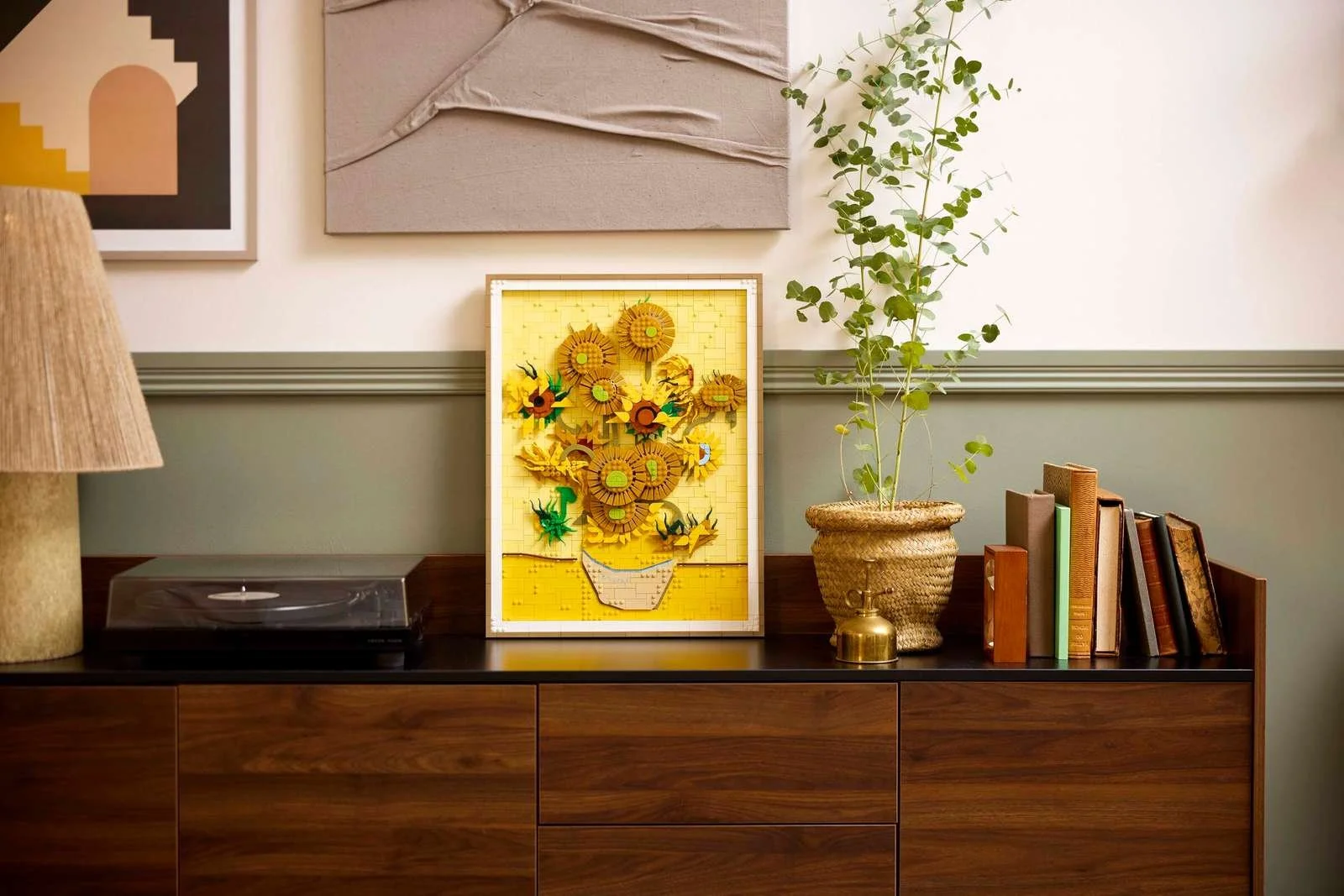 EGO Vincent van Gogh Sunflowers set leaning on a walnut sideboard beside a record player and eucalyptus.
