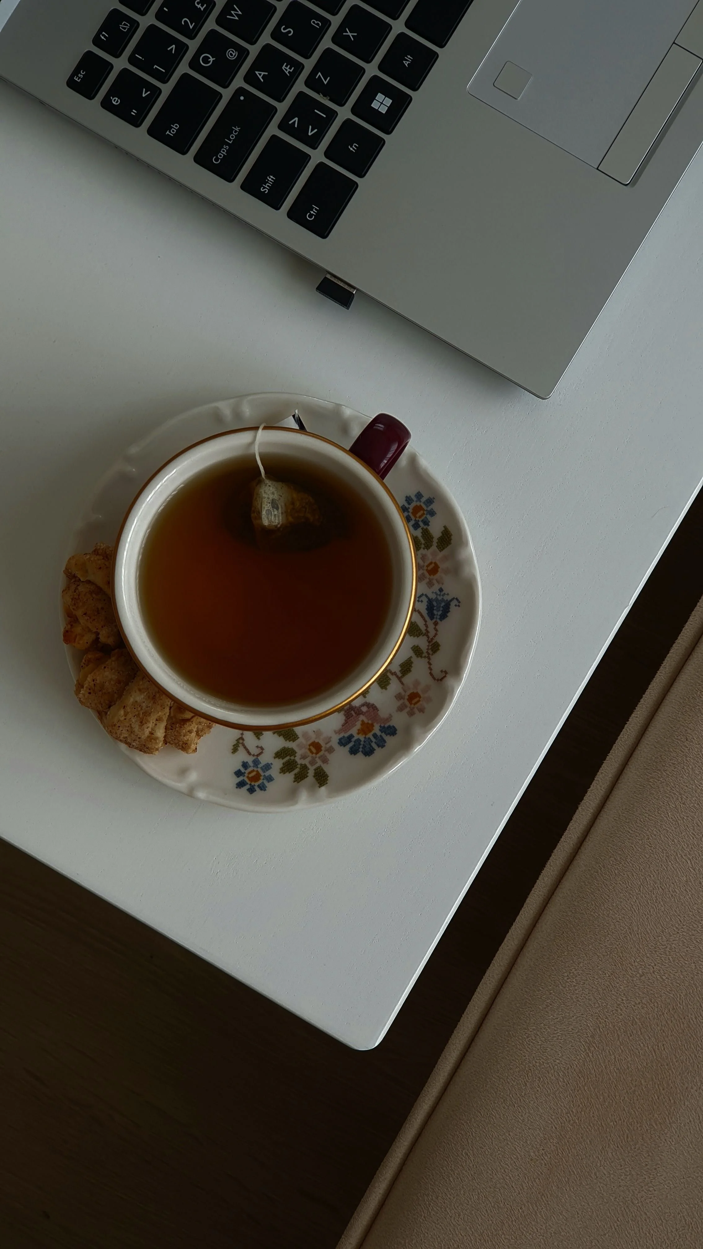 Tips for how to relieve stress every day is the blog post, this is a picture with a calming tea on a white dress, and a bit of a laptop showing