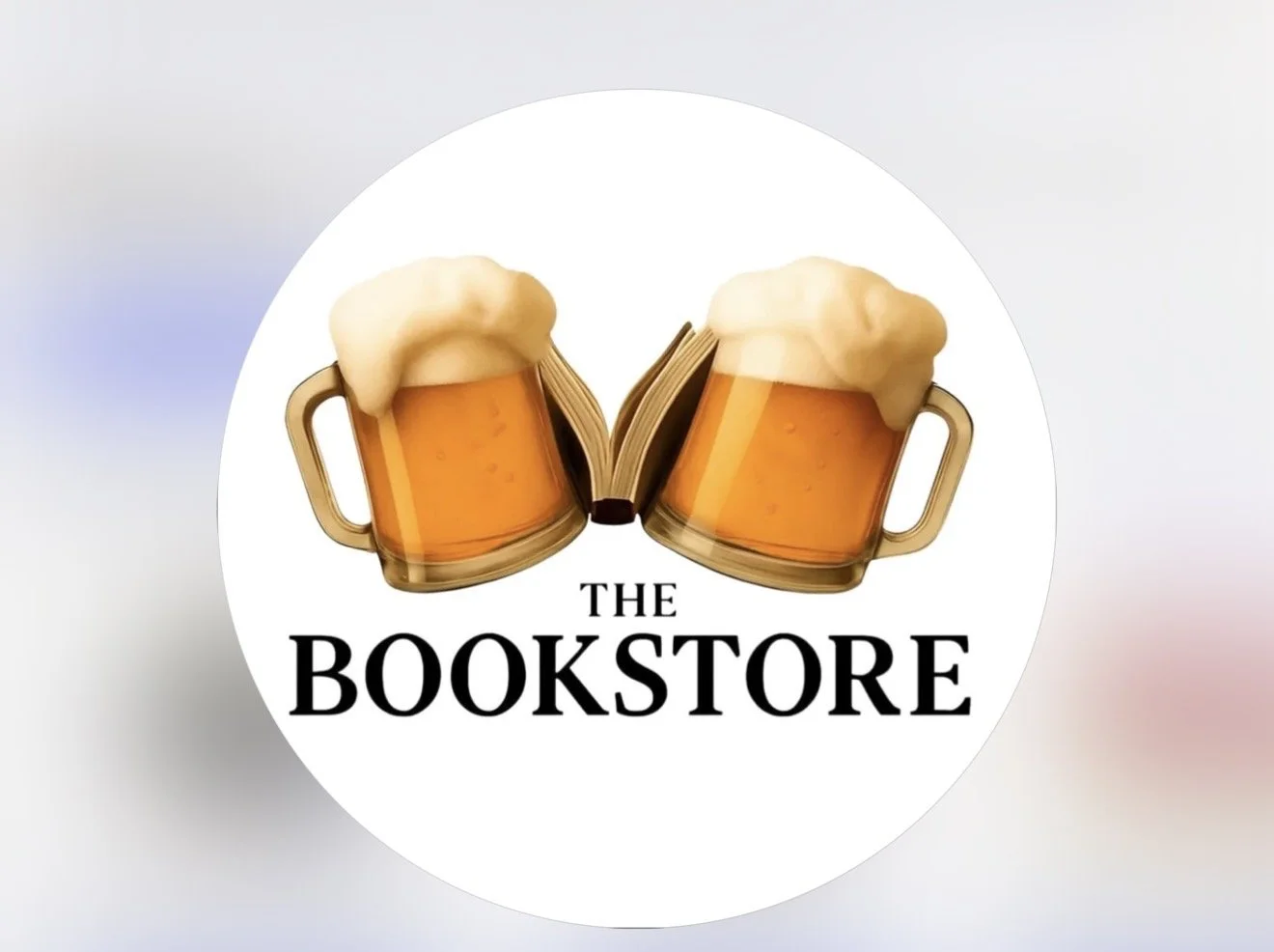 A circular logo with two beer mugs topped with foam, facing each other, with a book open between them, and the text 'The Bookstore' below.