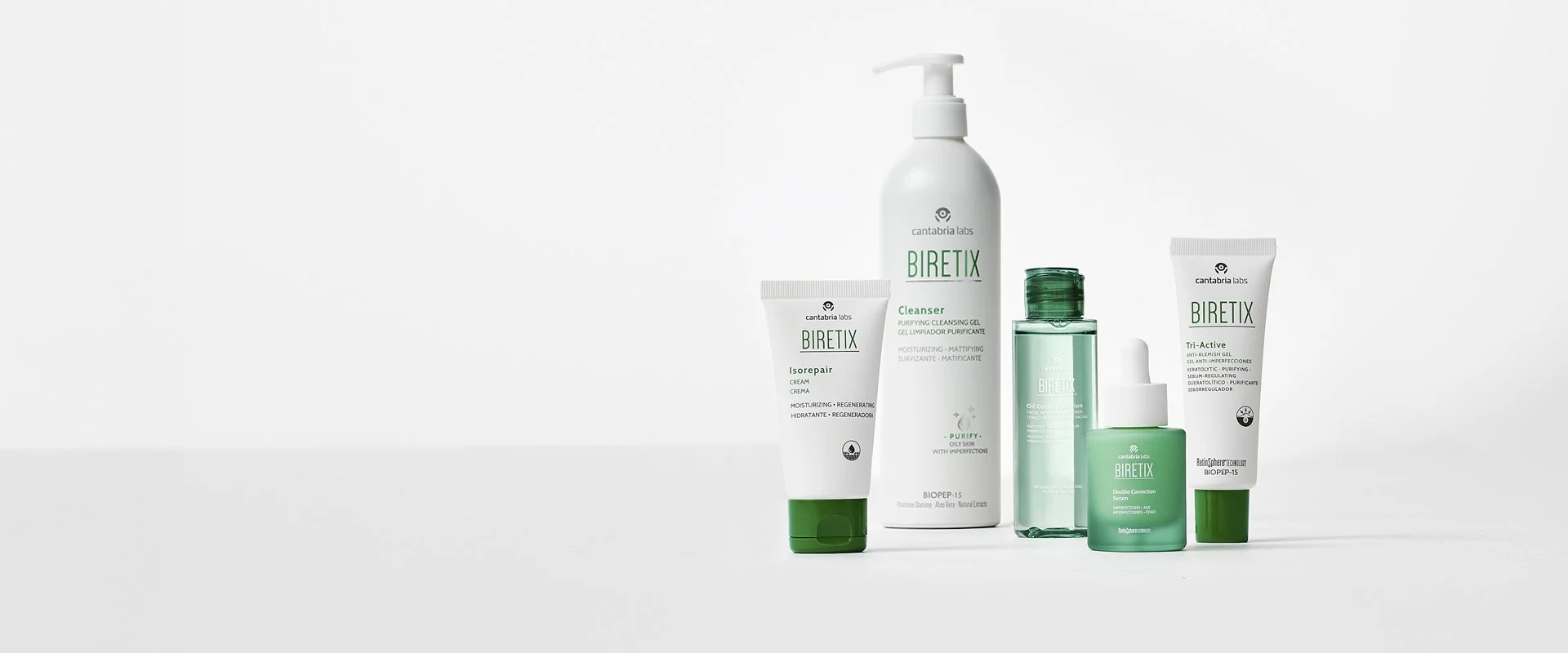 Collection of Biretix skincare products including cleanser, cream, serum, and gels, arranged on a white background.