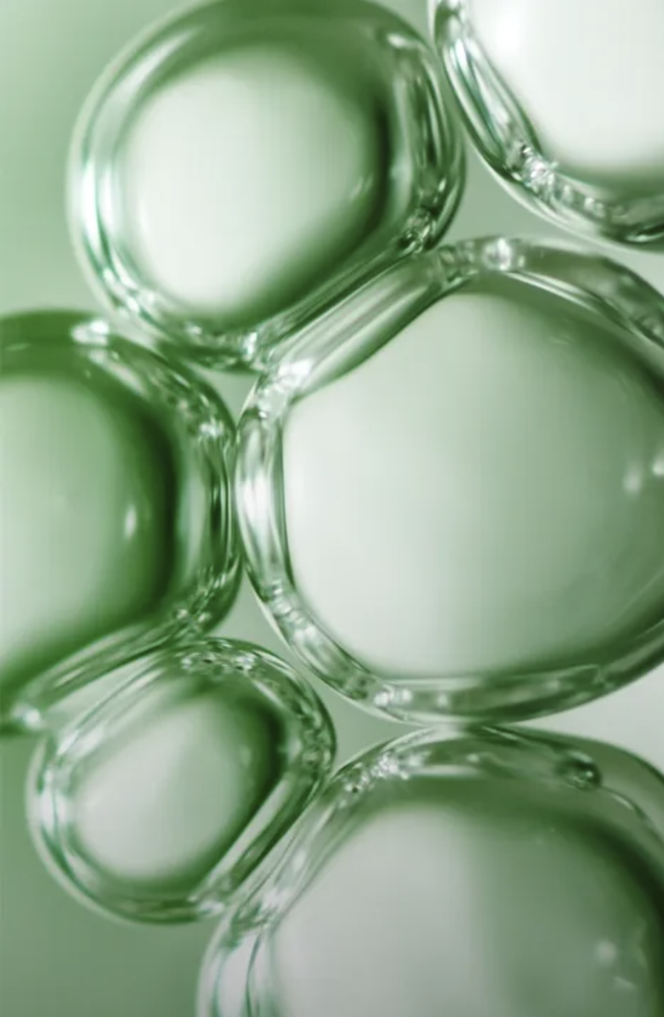 Close-up of several green glass test tubes or vials arranged in a cluster.