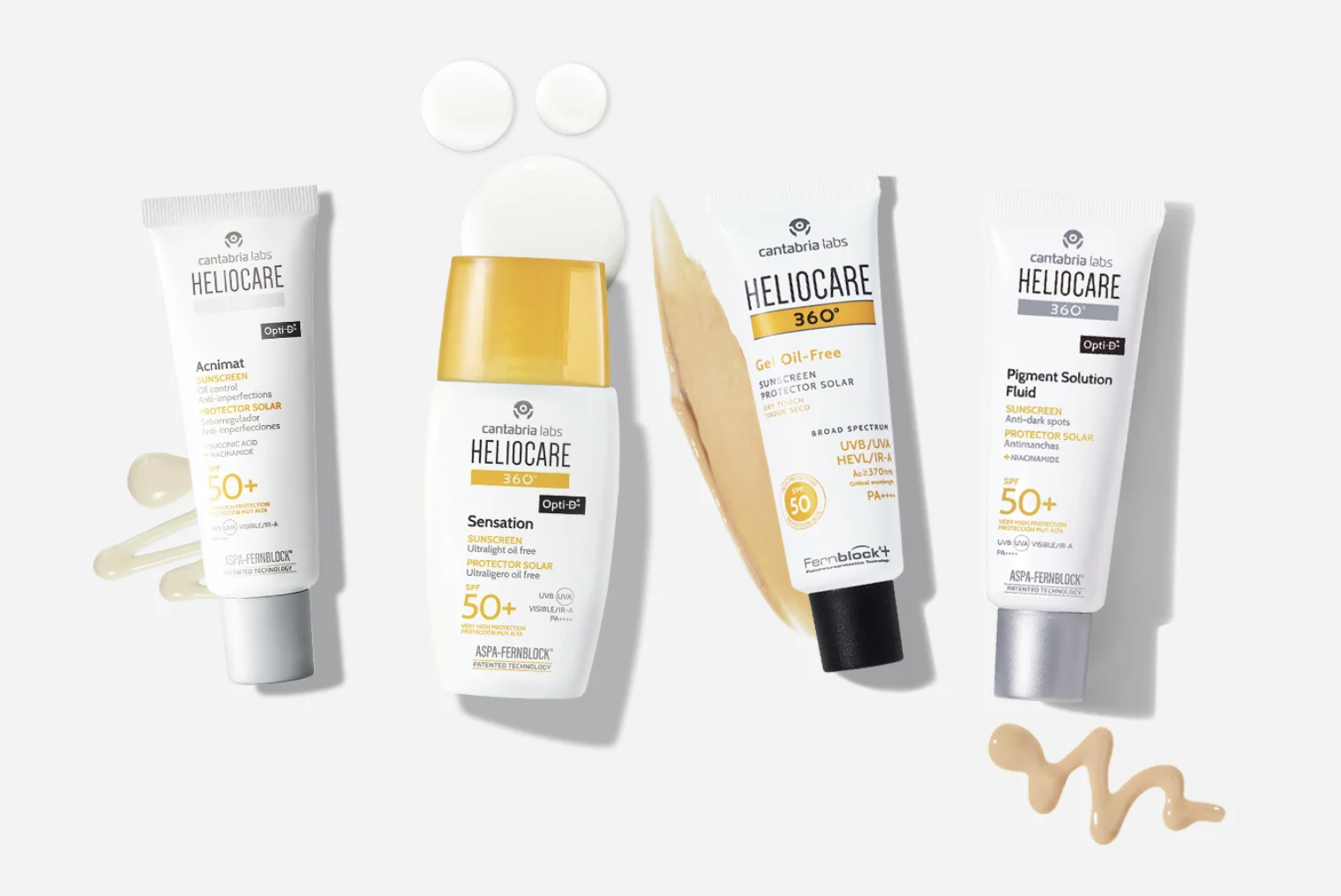 Four tubes of Cantabria Labs Heliocare sunscreen with various textures and labels, along with a black and yellow sunscreen bottle, some white circular objects, a beige swatch of SPF cream, and a beige wavy line of cream on a white background.
