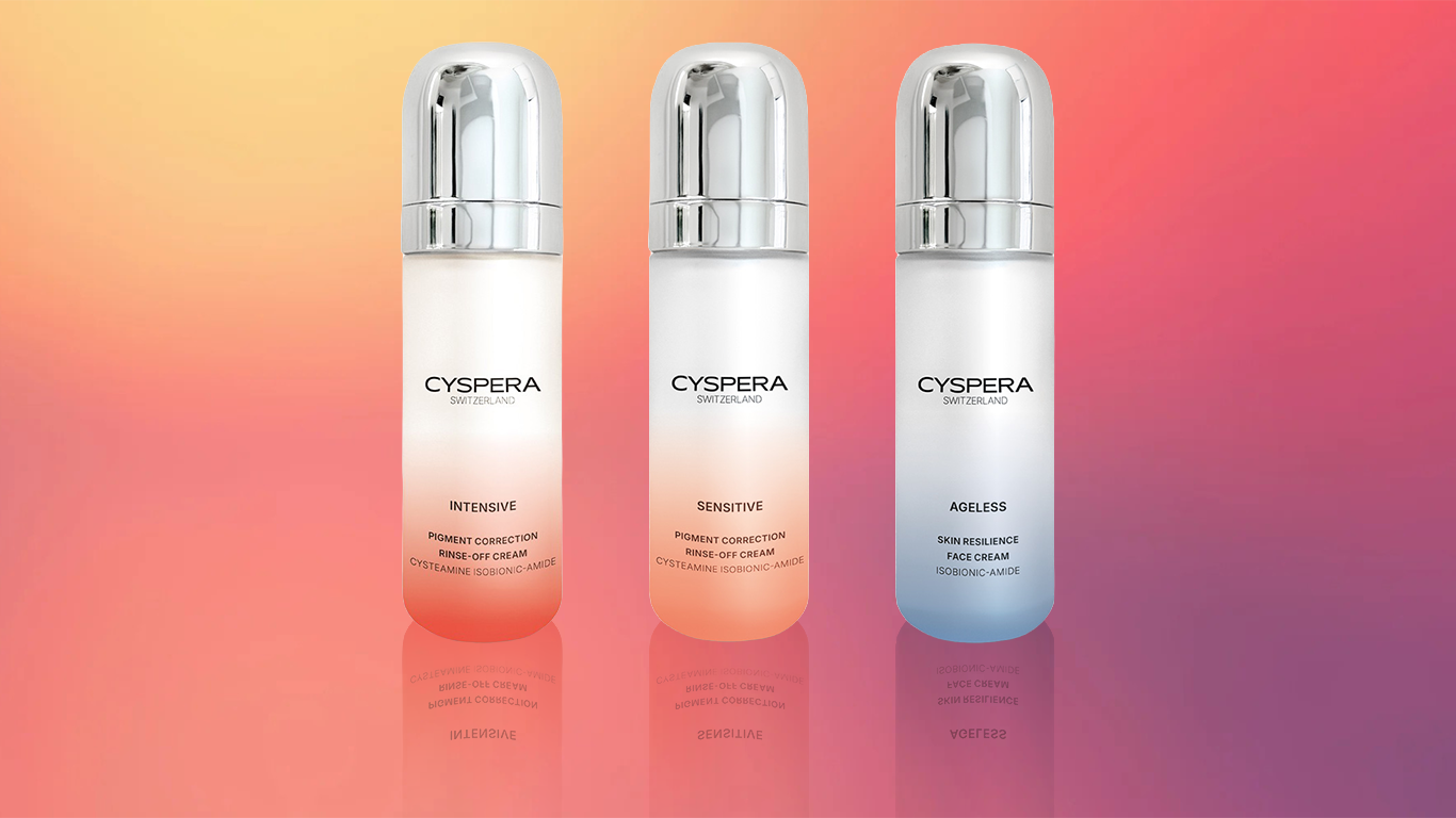 Three cylindrical bottles of skincare products from CYSPERA Switzerland with metallic caps placed against a gradient pink and orange background.