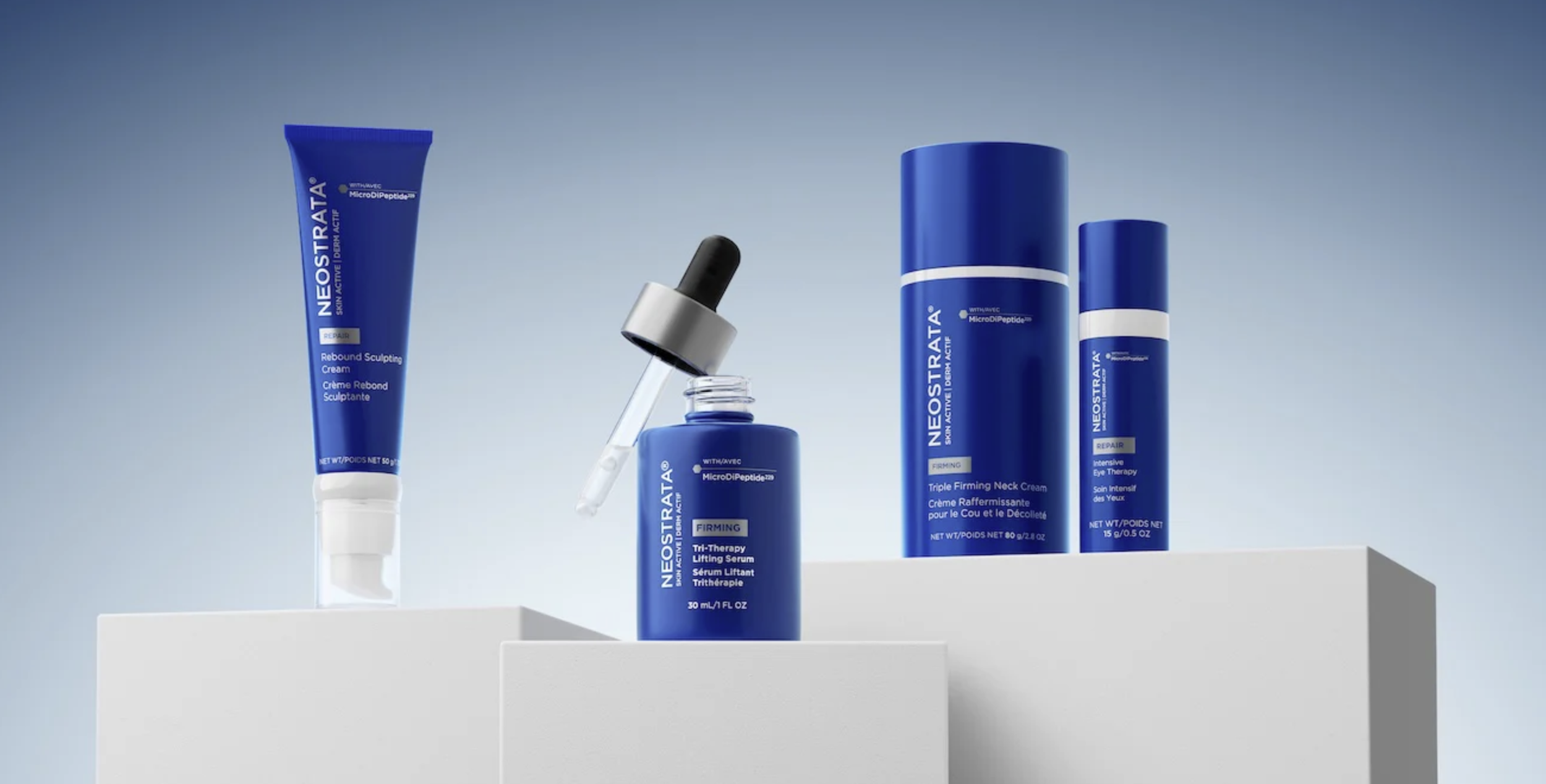 A collection of Neostrata skincare products on a white shelf against a light blue background, including creams and serums.