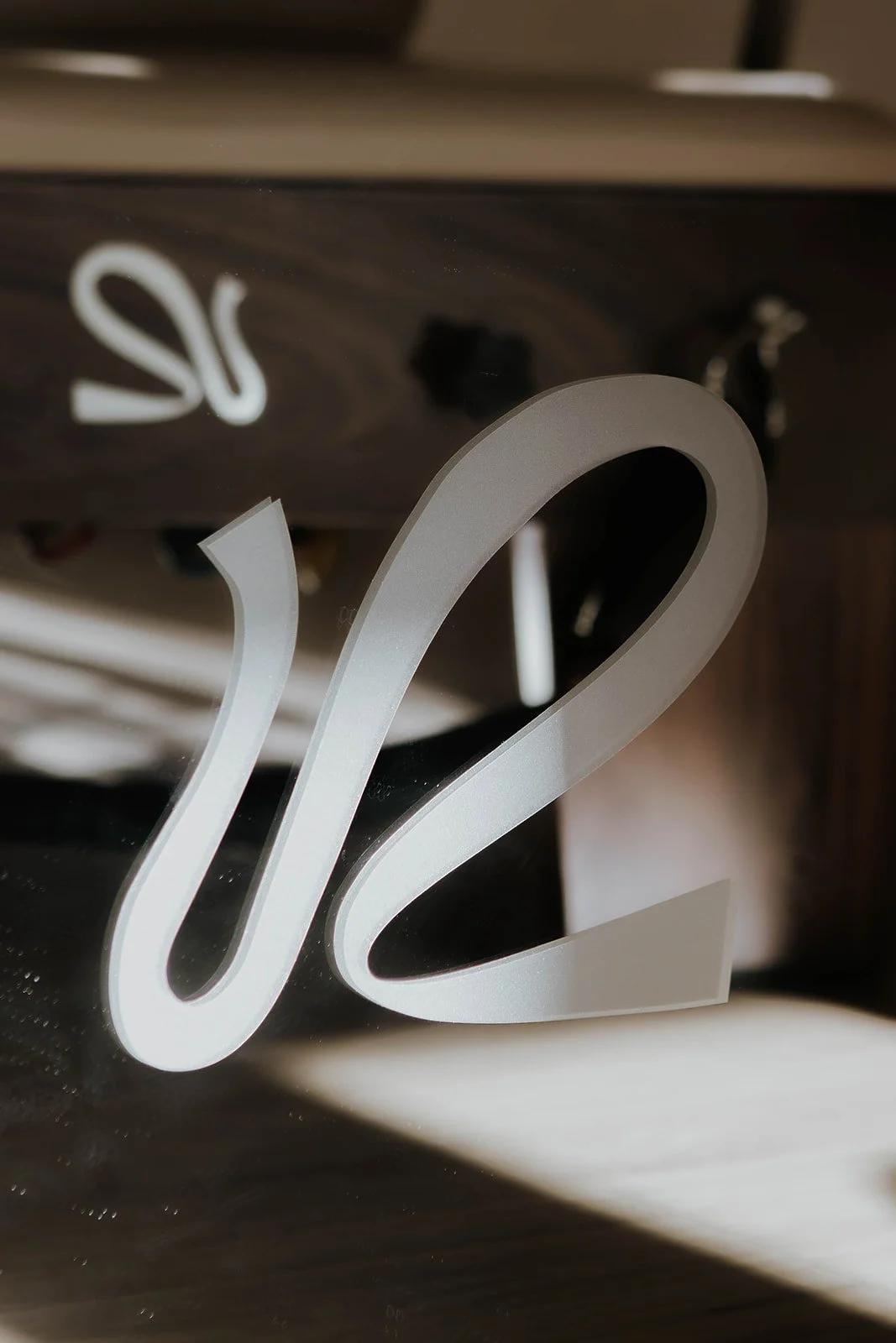 Close-up of a Rise reformer pilates bed logo