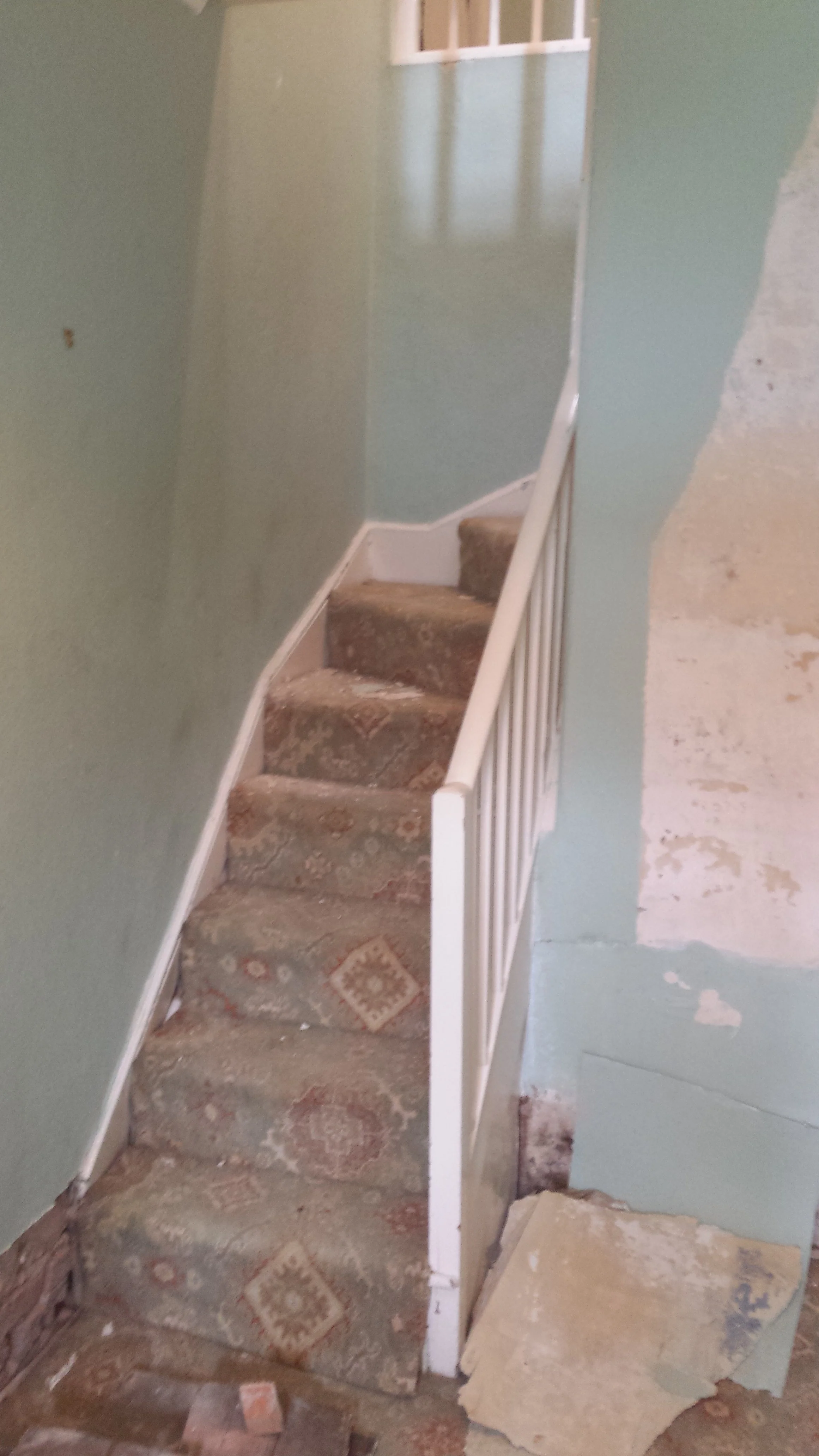An old worn out staircase before the installation of a bespoke staircase and wall panelling installation completed as part of a home refurbishment project in Bridlington.