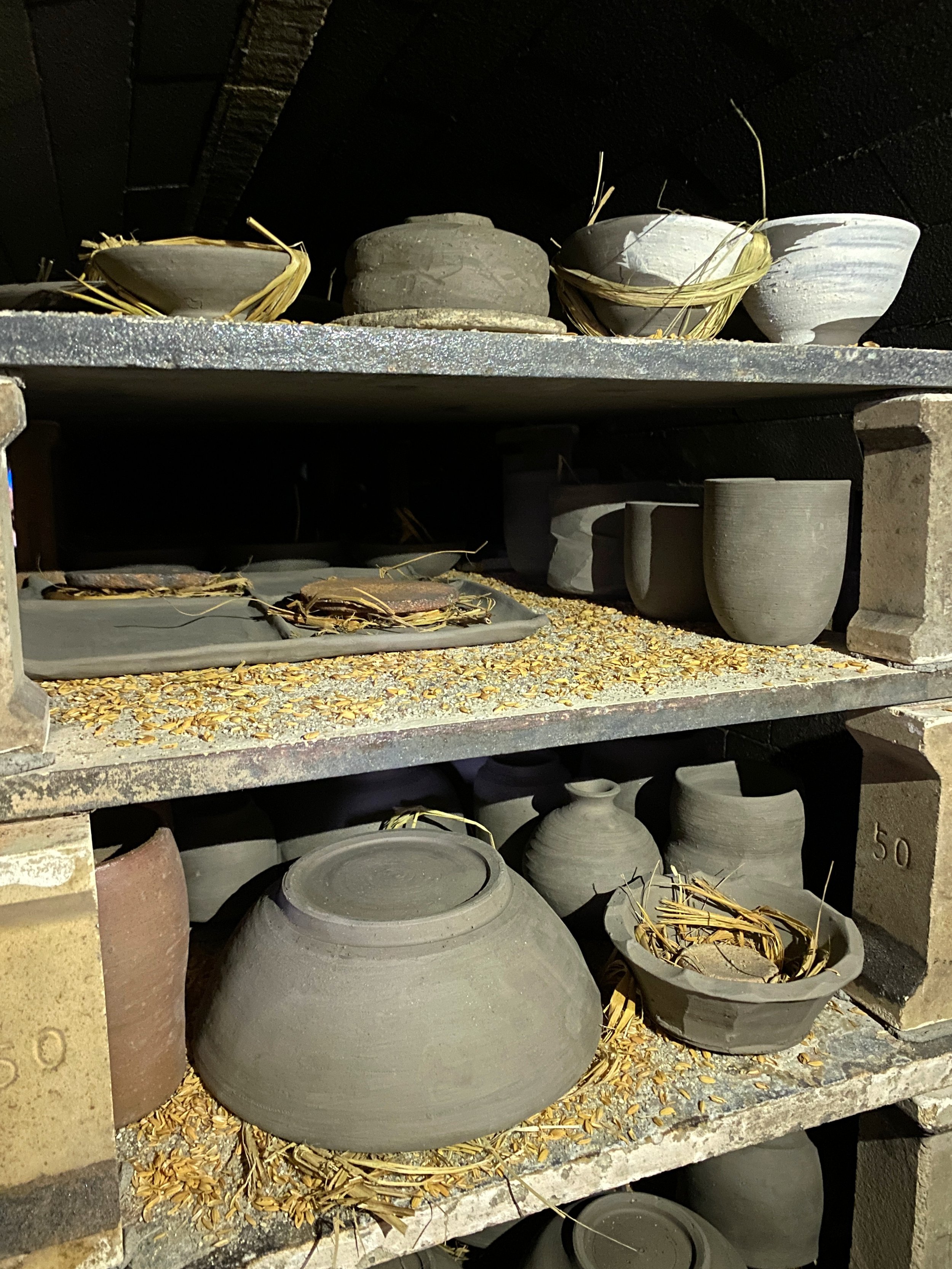 Inside the second chamber of the noborigama kiln, loaded with pieces for firing.