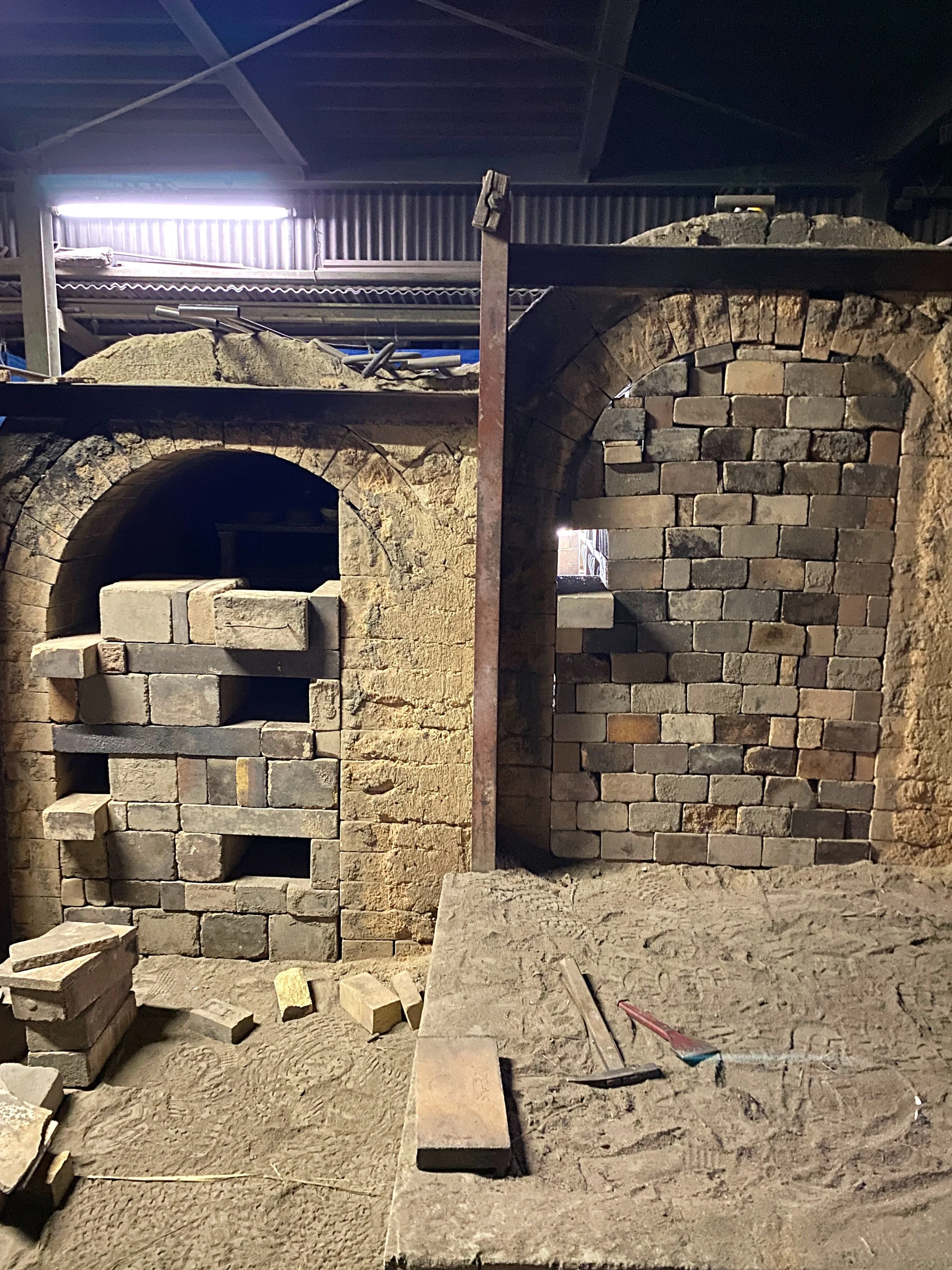 Sealing the noborigama kiln in preparation for firing.