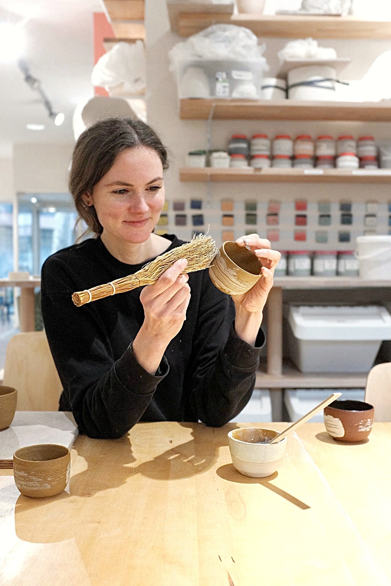 Applying slip to handmade ceramic cups in my studio in Mainz, Germany.