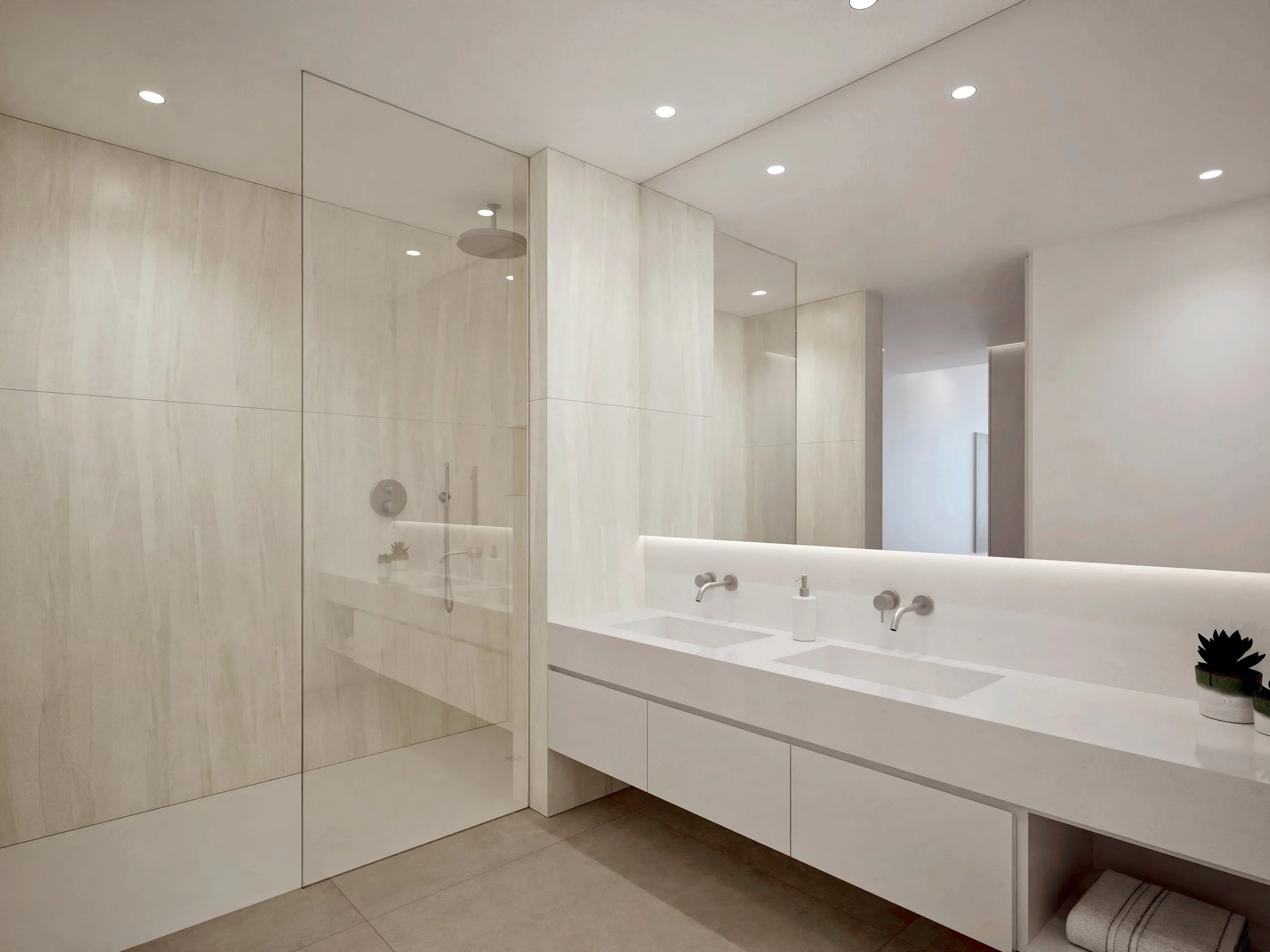 A modern bathroom with white walls, large mirror, white vanity with two sinks, small plant on the right side of the vanity, recessed lighting in the ceiling, and a glass shower enclosure with a rainfall showerhead.