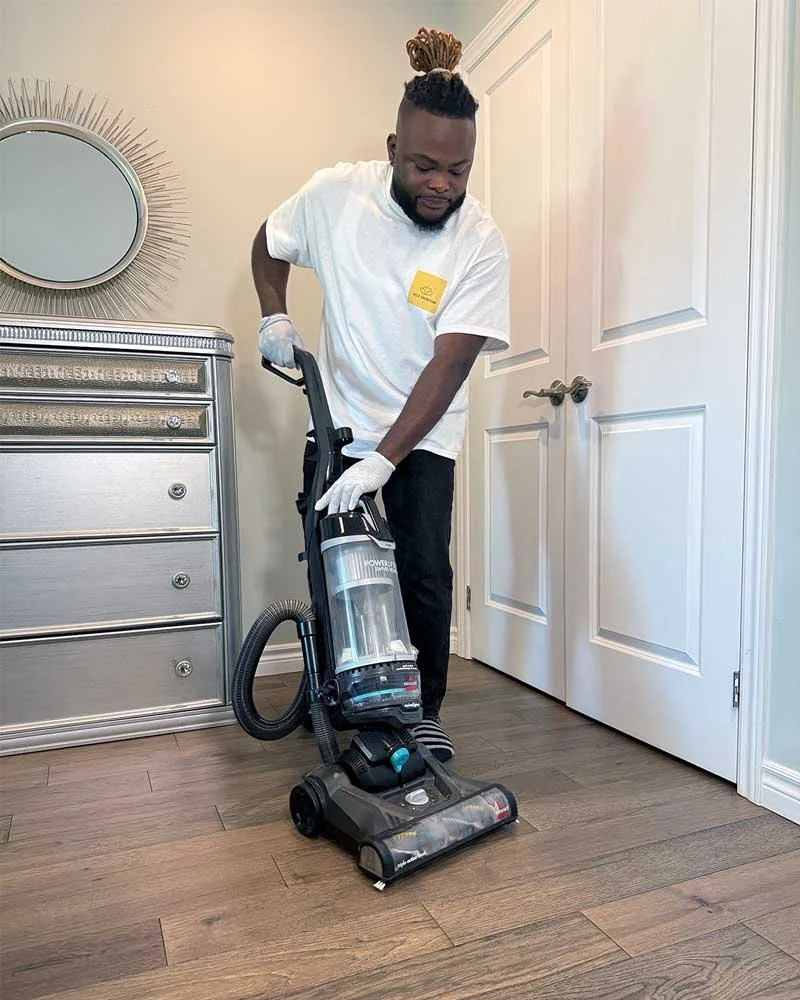 Man vacuuming hardwood floors