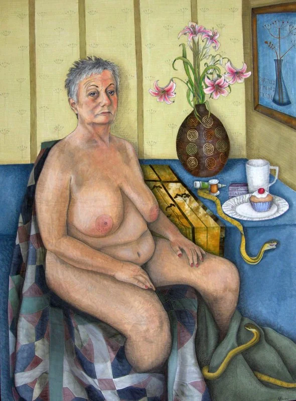 An art quilt by Annabel Rainb depicting a mature woman seated nude on a patchwork quilt next to a table with a vase of pink lilies, a cup, small bottles, a pastry, and a small snake. The background includes a wall with wallpaper and a framed picture.