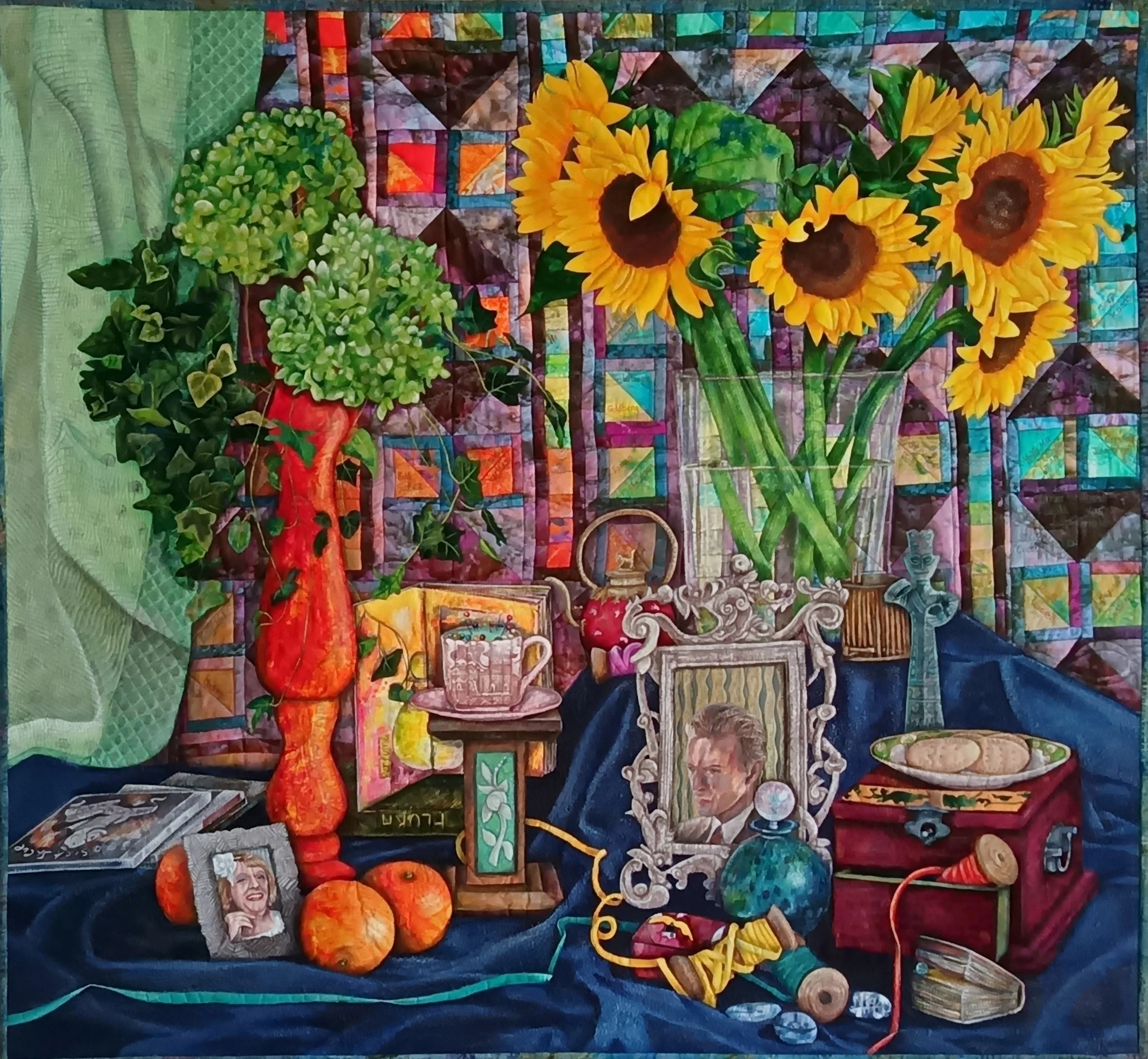 Self Portrait In The Third Person by Annabel Rainbow featuring sunflowers, green foliage, an orange vase, oranges, photo frames, teacup, and various decorative objects against a geometric patterned background.