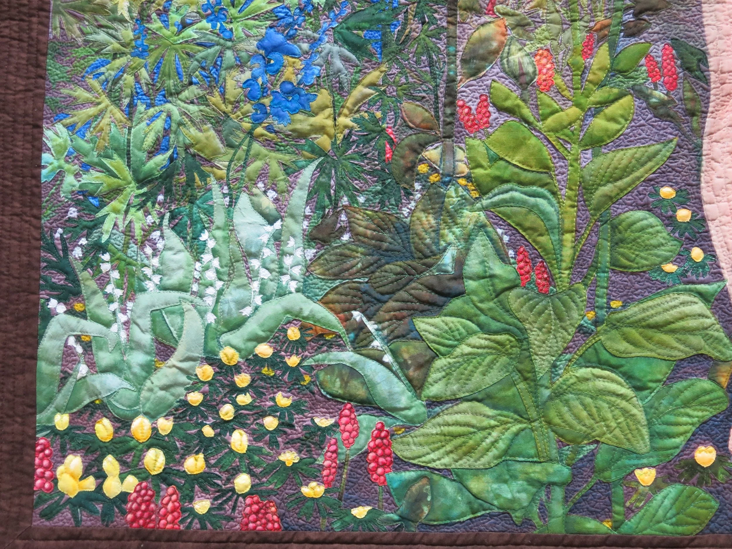 Poisonous Plant by Annabel Rainbow. A quilt in the collection of the Quilt Museum in York. A colorful quilt depicting various plants, flowers, and foliage with intricate quilting details.