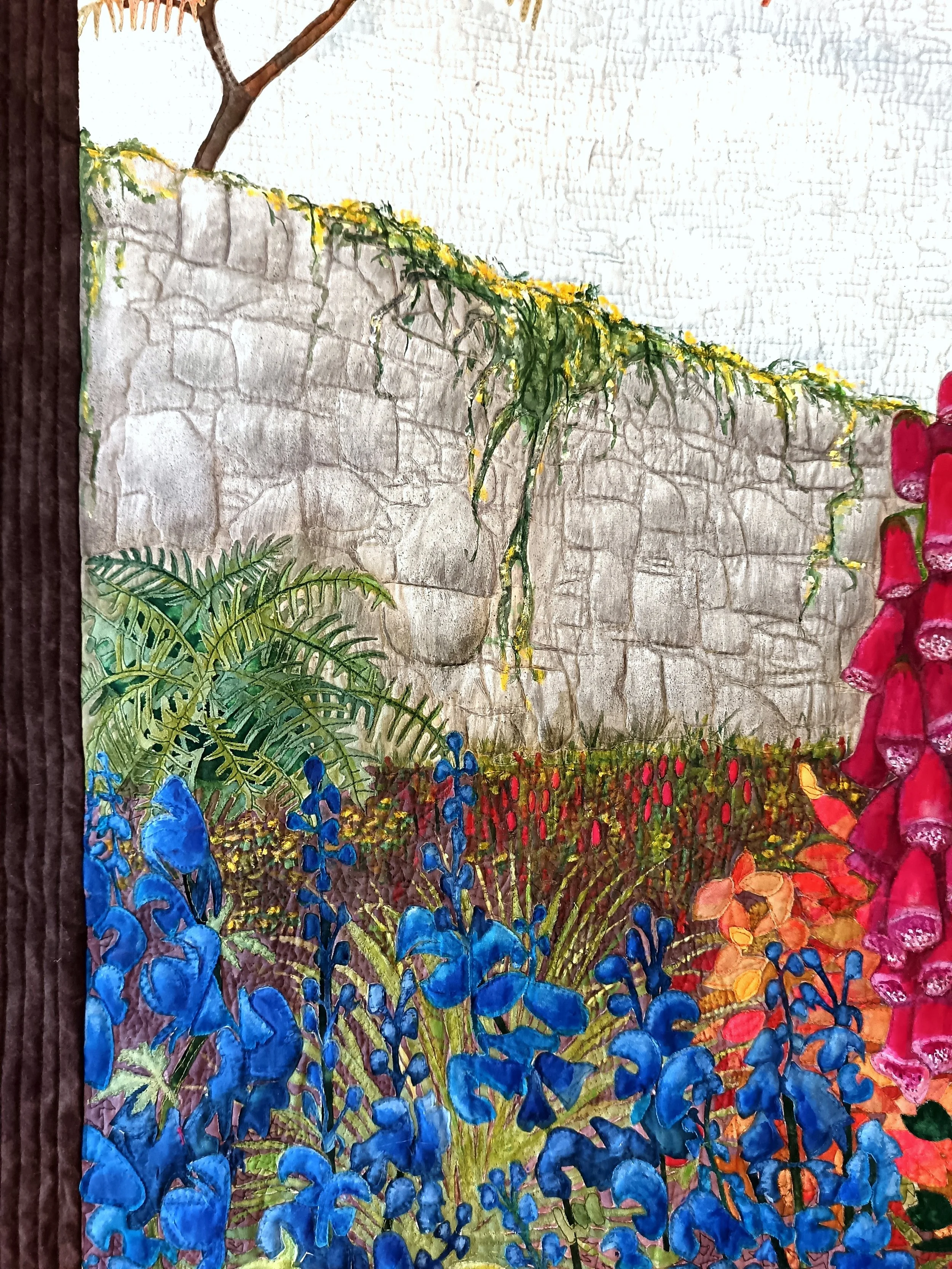 Colorful mural of a garden scene with blue flowers, green ferns, and a stone wall, with a tree branch visible at the top.