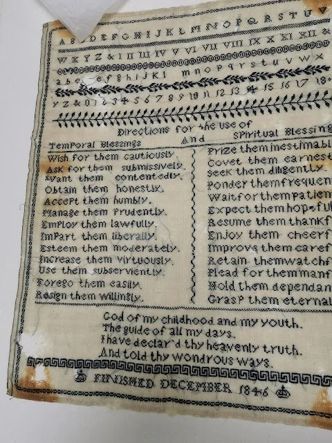 Antique embroidered sampler showing English alphabet and numbers, with directions for temporal and spiritual blessings, dated December 1846.