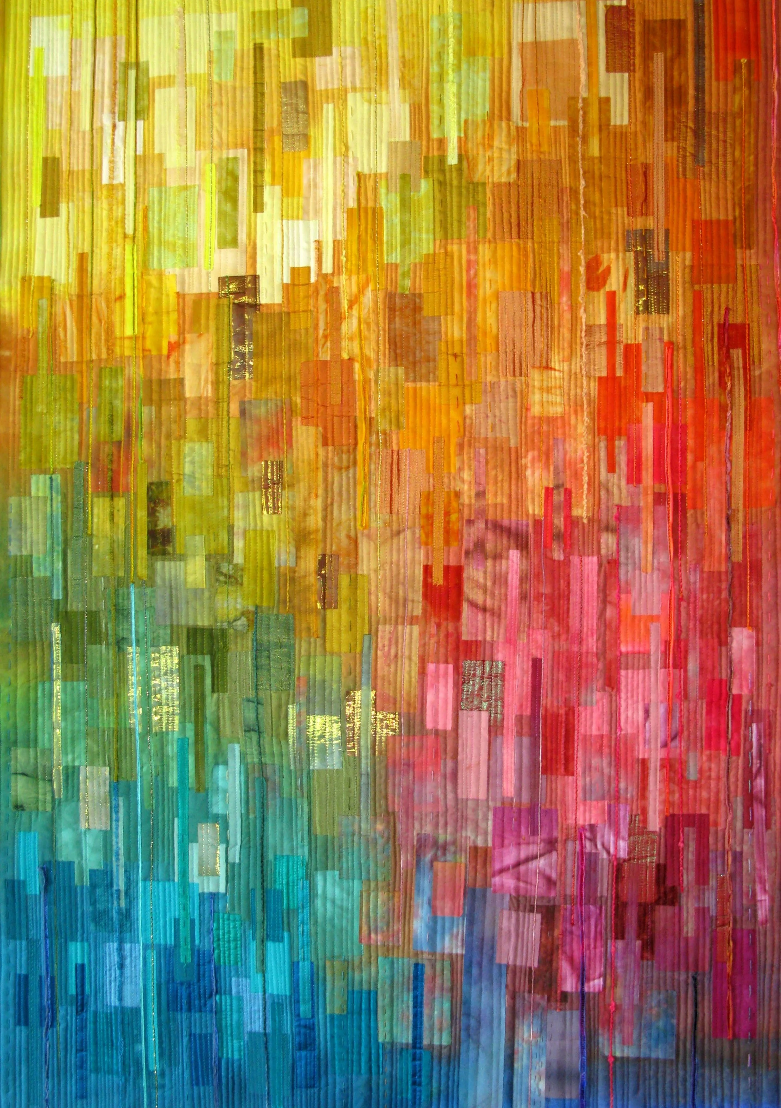 Abstract textile art with vertical patchwork of colorful fabric strips in gradient of yellow, green, blue, pink, and orange hues.