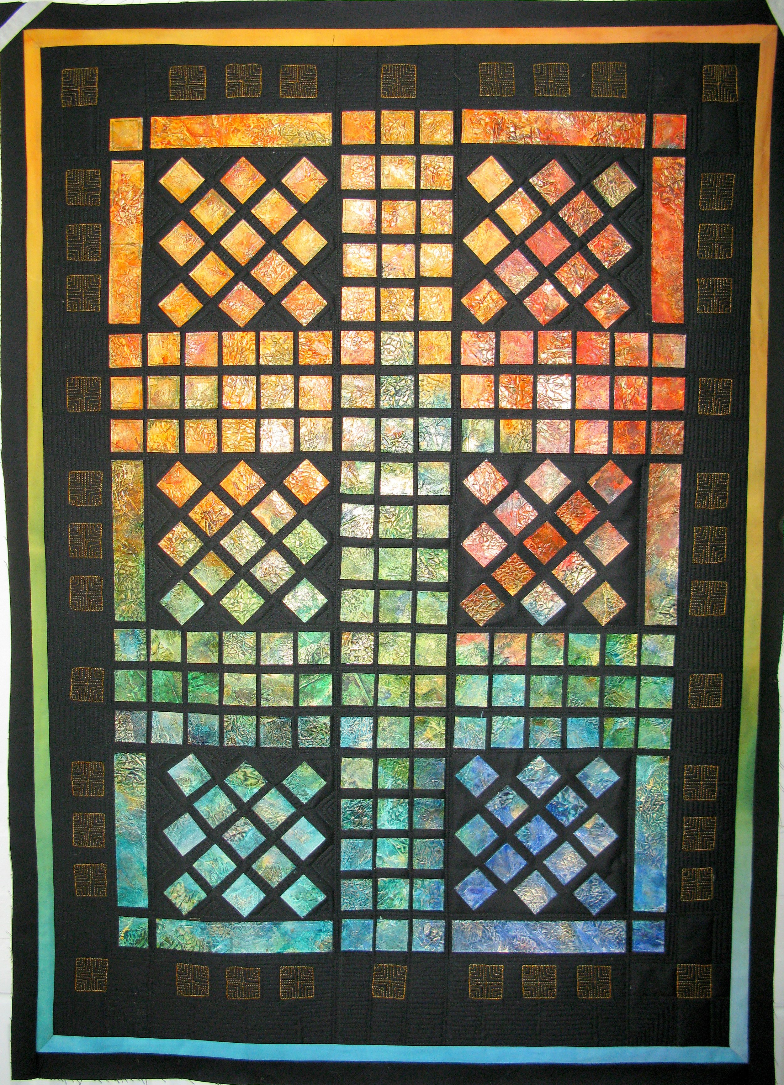 Colorful patchwork quilt with geometric patterns on a black background