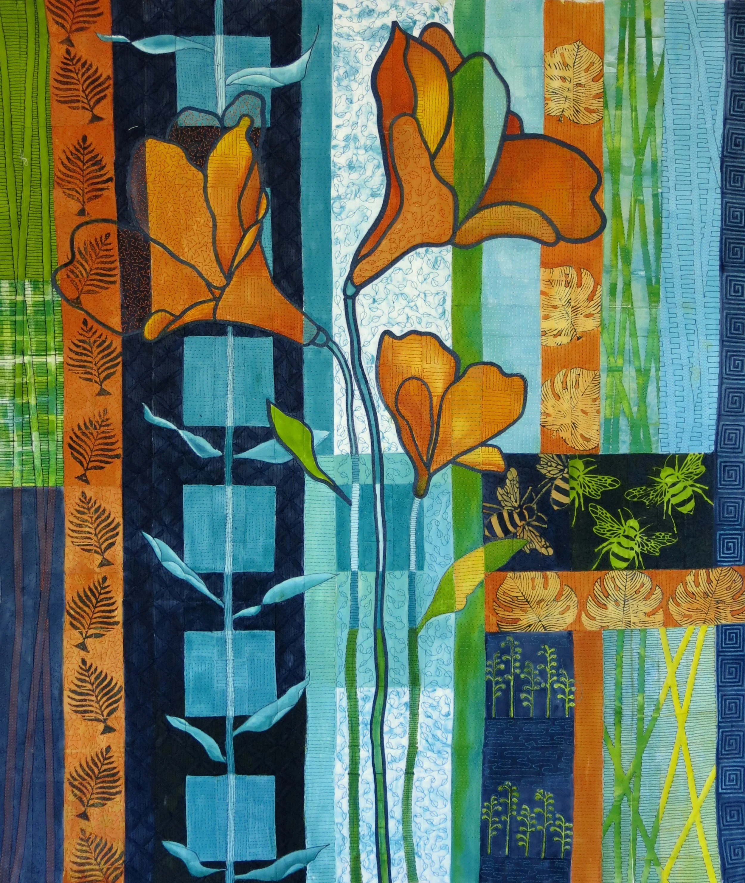 Colorful quilt with floral and geometric patterns, featuring orange flowers, green leaves, and blue squares.
