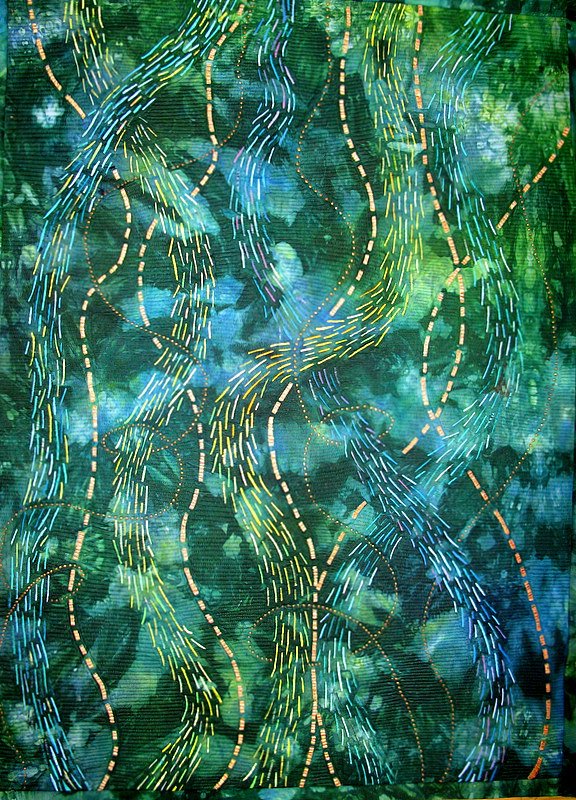 Abstract textile artwork with green and blue swirls and dashed lines