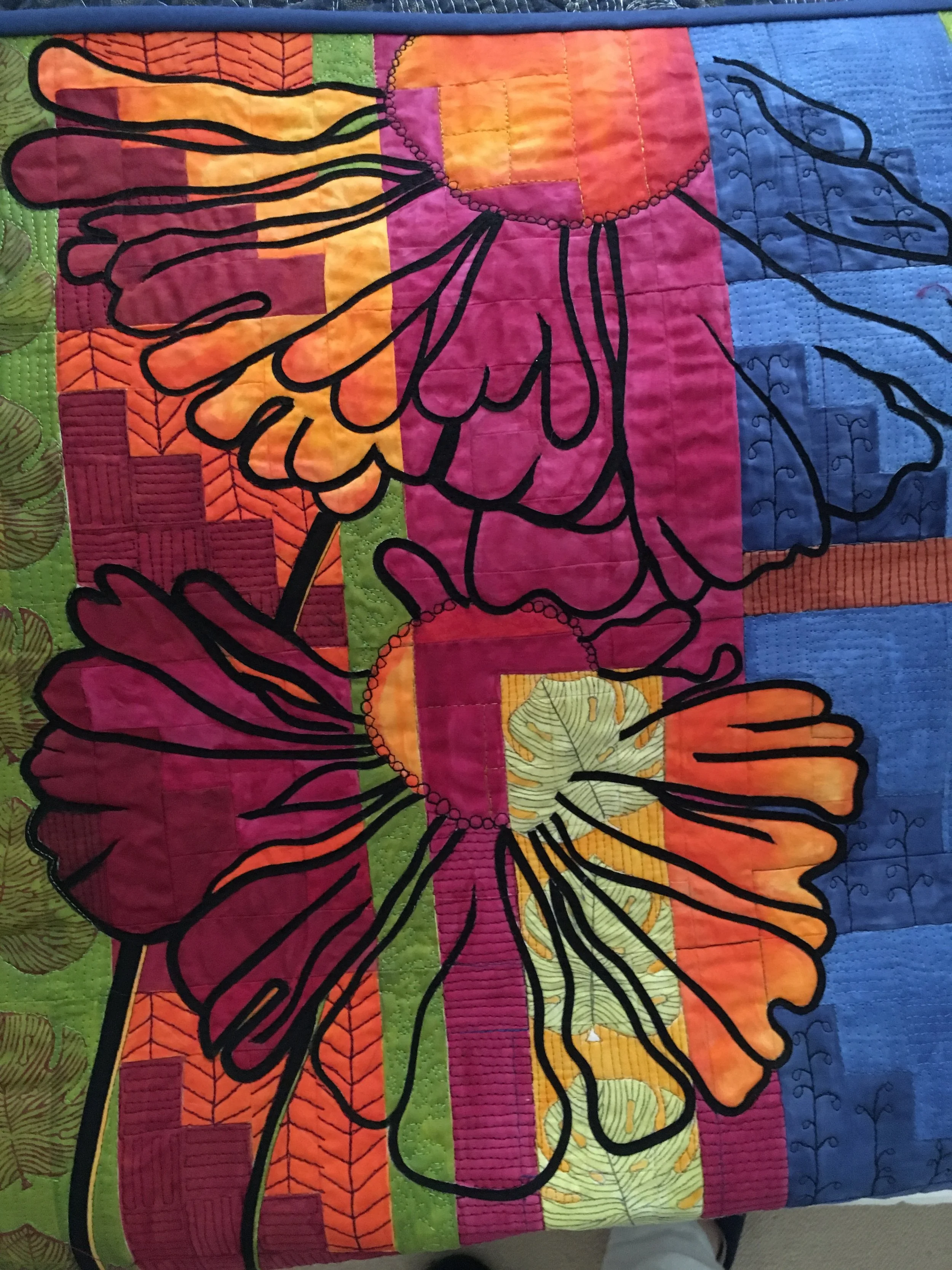 Quilt with colorful abstract flower pattern