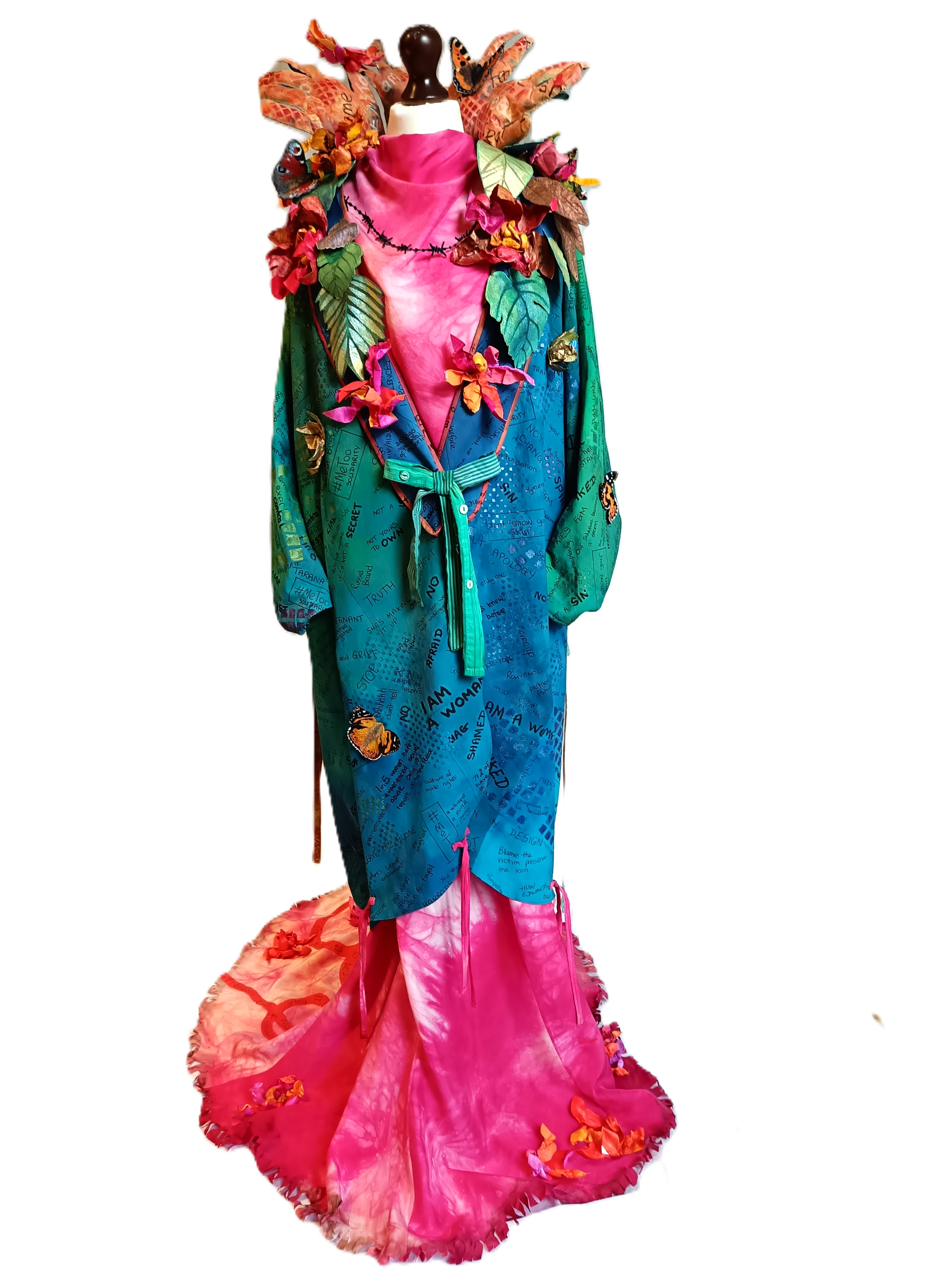 Colorful dress with graffiti-style writing, butterflies, and vibrant fabric flowers, resembling a jungle theme.